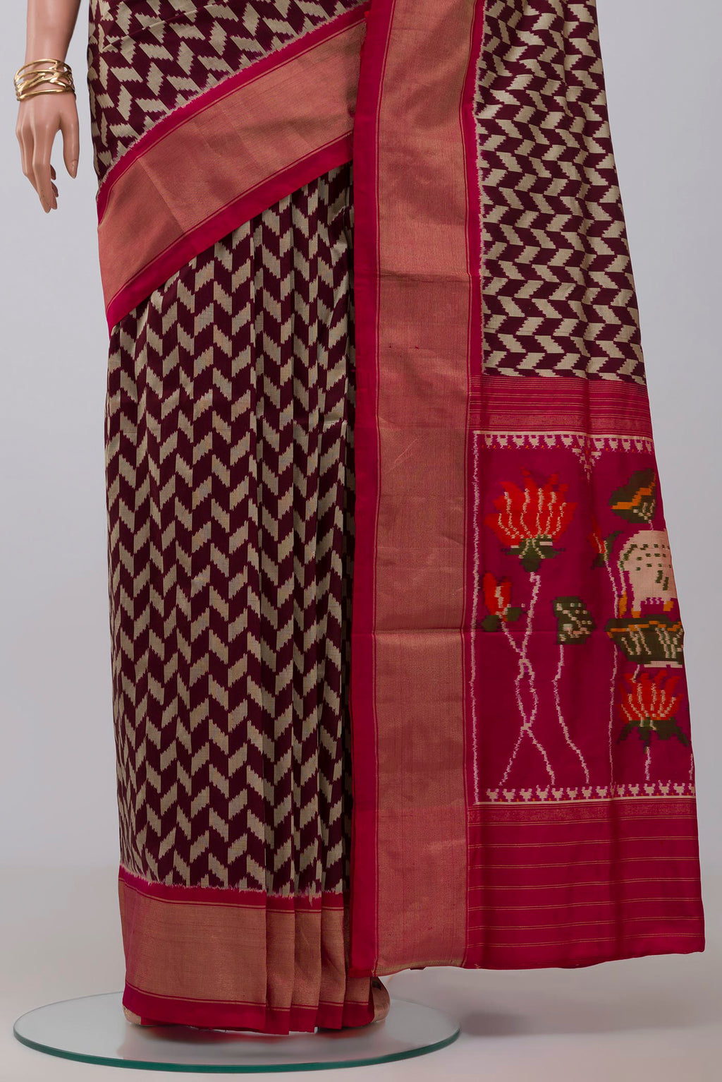 Pleats and pallu of Brown Pochampally Silk Saree with Ikat design on the body and Zari Border. 