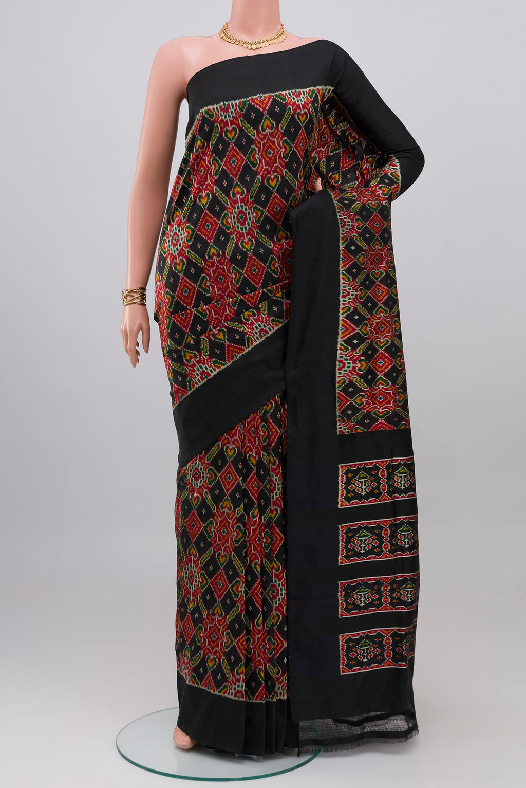Black Pochampally Silk Saree with Ikat design on the body and Plain Border.  displayed on a mannequin