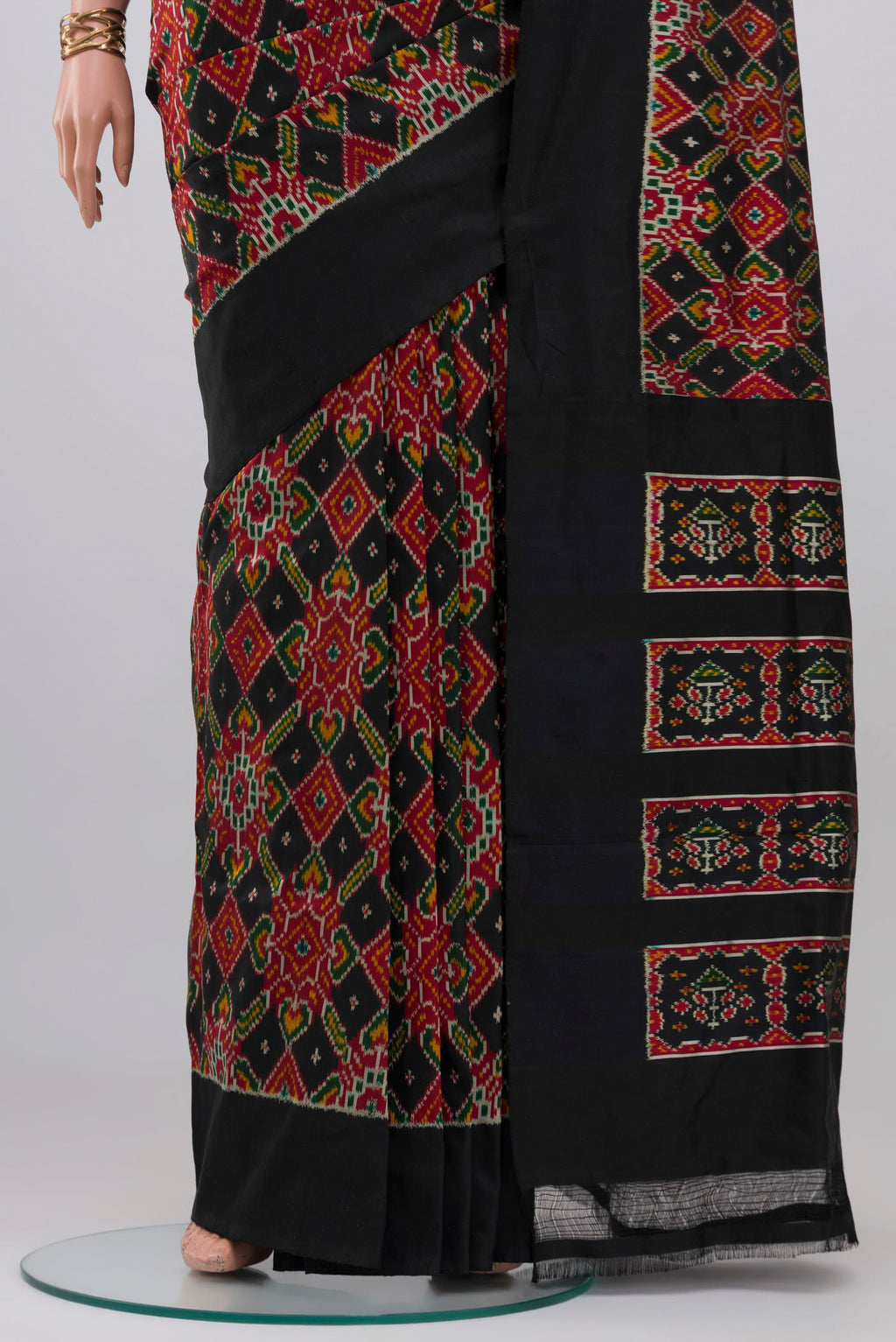 Pleats and pallu of Black Pochampally Silk Saree with Ikat design on the body and Plain Border. 