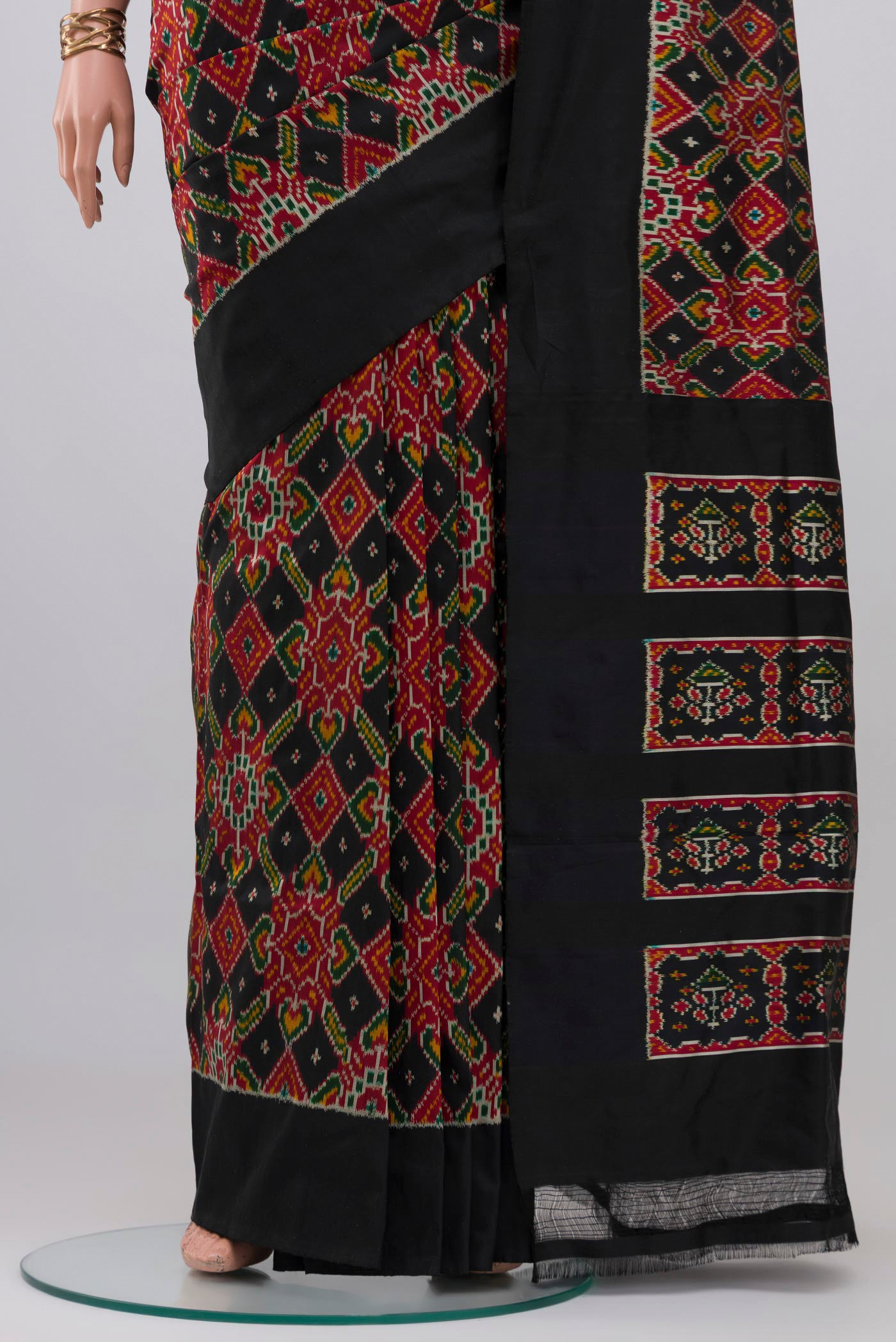 Pleats and pallu of Black Pochampally Silk Saree with Ikat design on the body and Plain Border. 