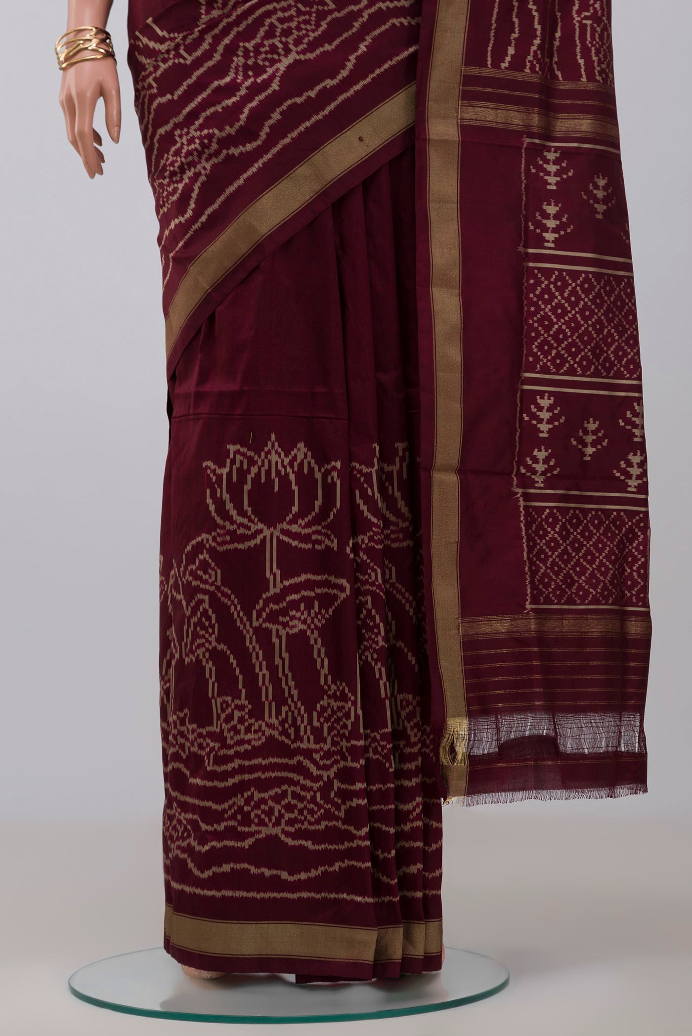 Pleats and pallu of Brown Pochampally Silk Saree with Ikat design on the body and Zari Border. 