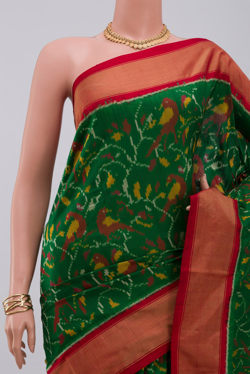 Border image of Green Pochampally Silk Saree with Ikat design on the body and Zari Border. 
