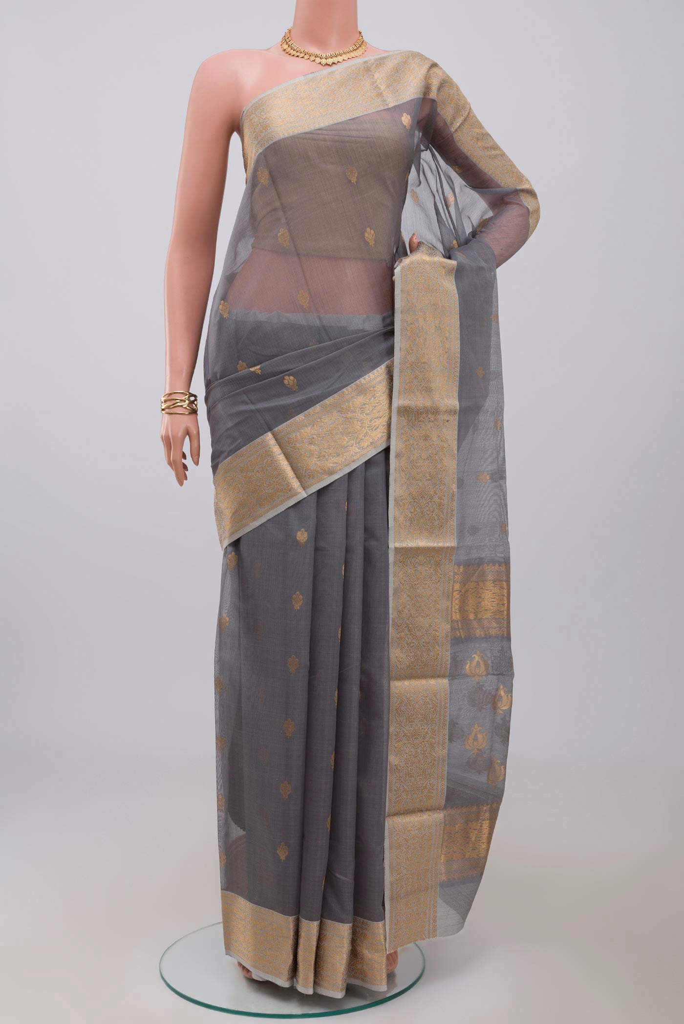 Grey Chanderi Silk Cotton Saree with Zari Butta on the body and Zari Border.  displayed on a mannequin