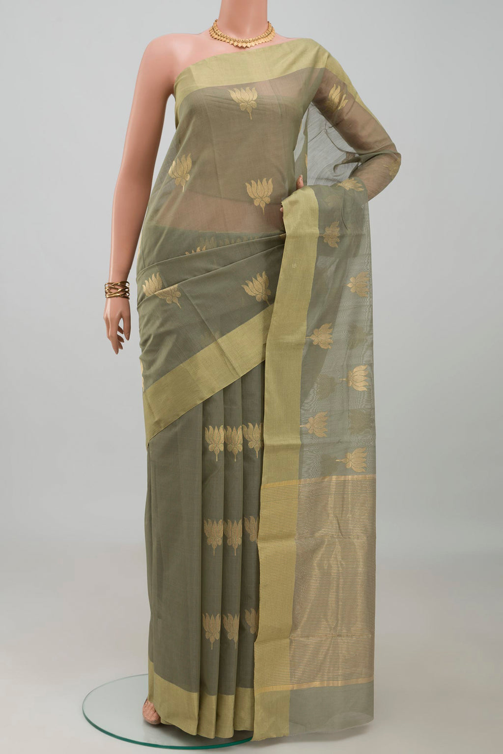 Sage Green Chanderi Silk Cotton Saree with Zari Butta on the body and Zari Border.  displayed on a mannequin