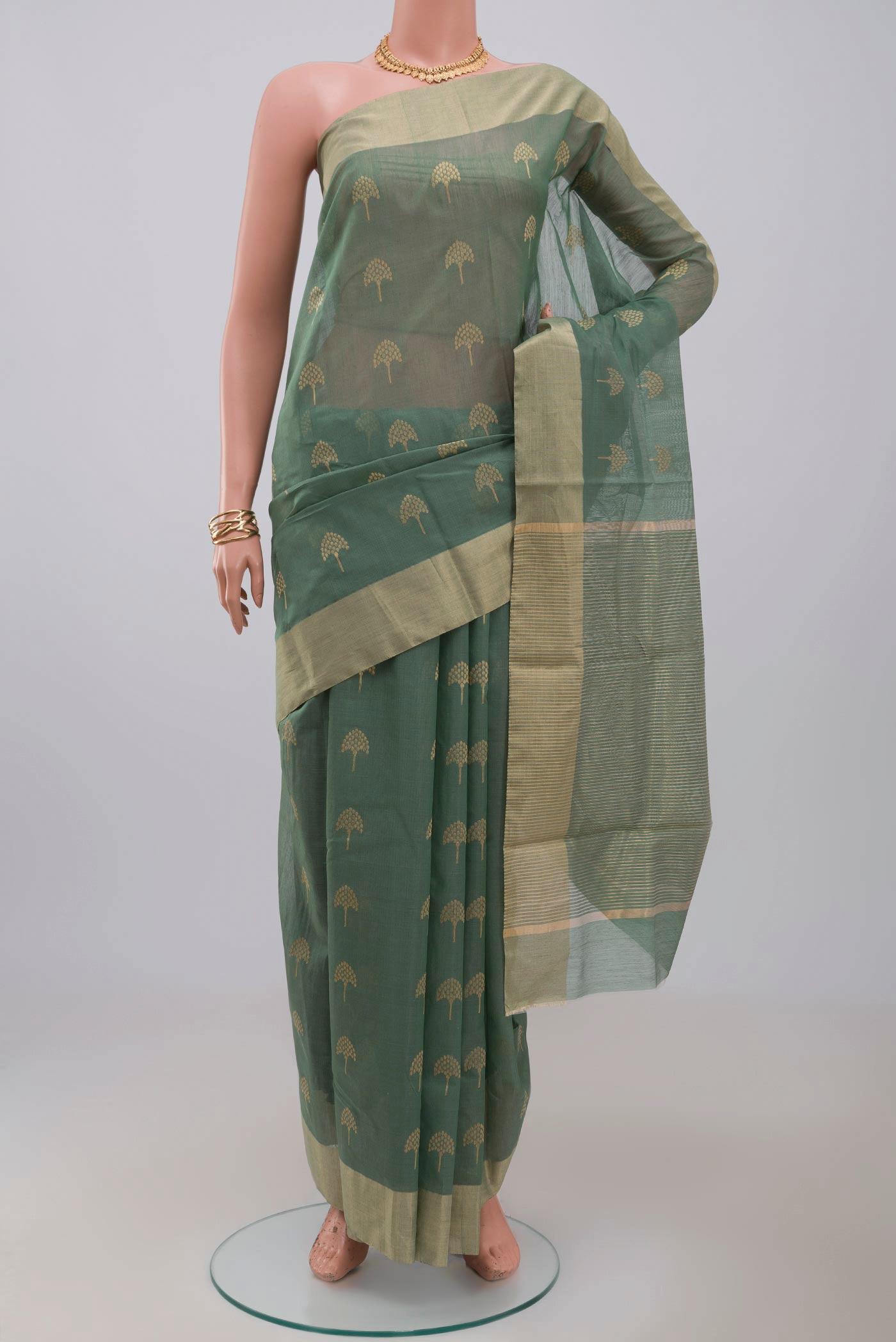 Pista Green Chanderi Silk Cotton Saree with Zari Butta on the body and Zari Border.  displayed on a mannequin
