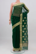 Bottle Green Chanderi Silk Cotton Saree with Zari Butta on the body and Zari Border.  displayed on a mannequin