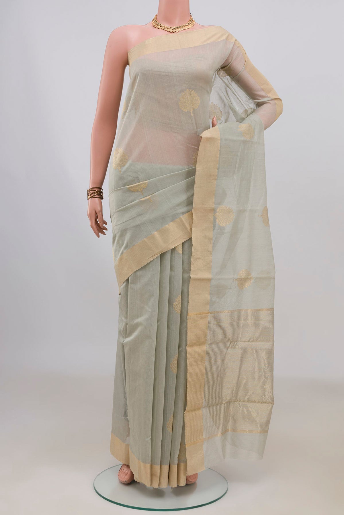 Grey Chanderi Cotton Saree with Zari Butta on the body and Zari Border.  displayed on a mannequin