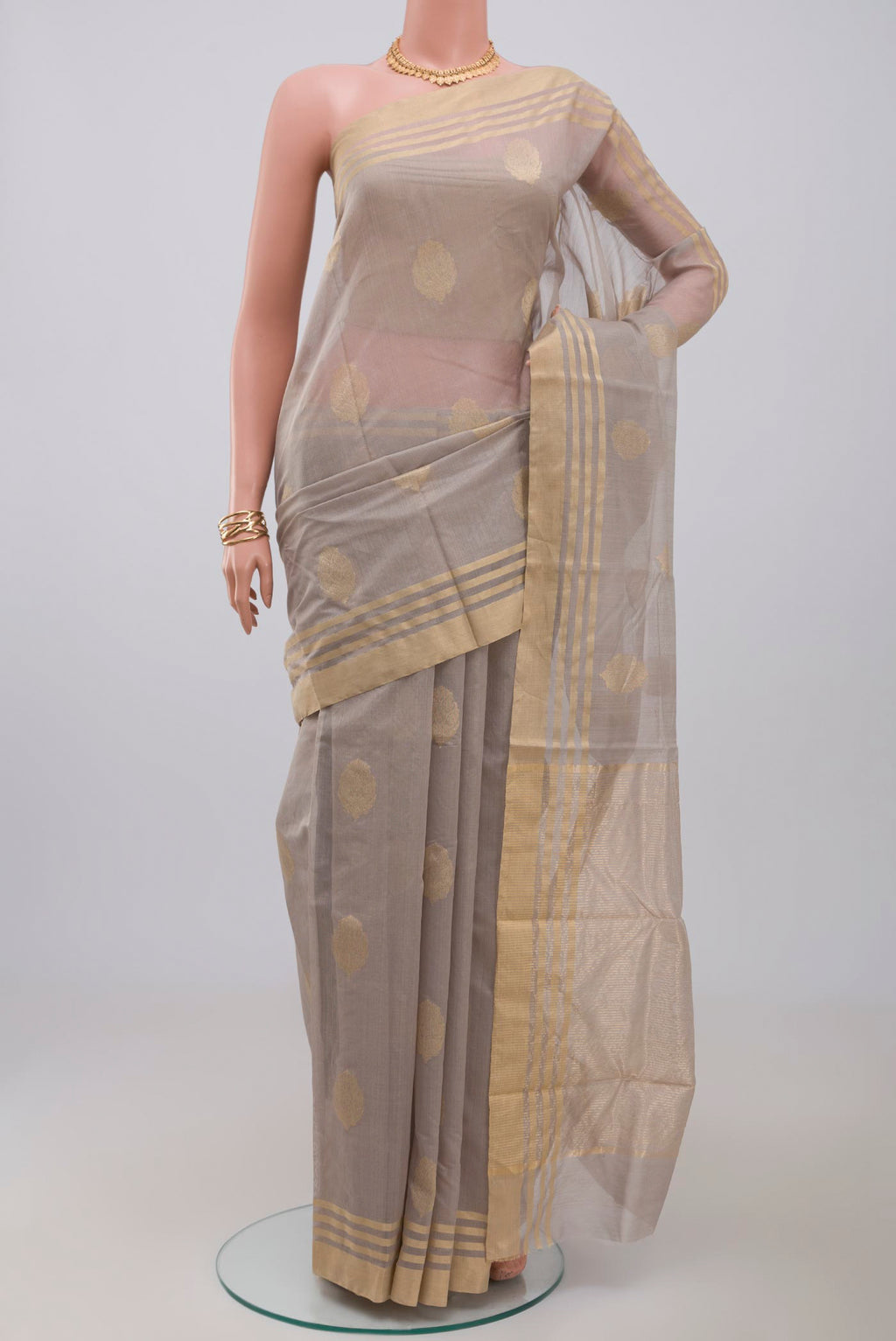 Grey Chanderi Silk Cotton Saree with Zari Butta on the body and Zari Border.  displayed on a mannequin