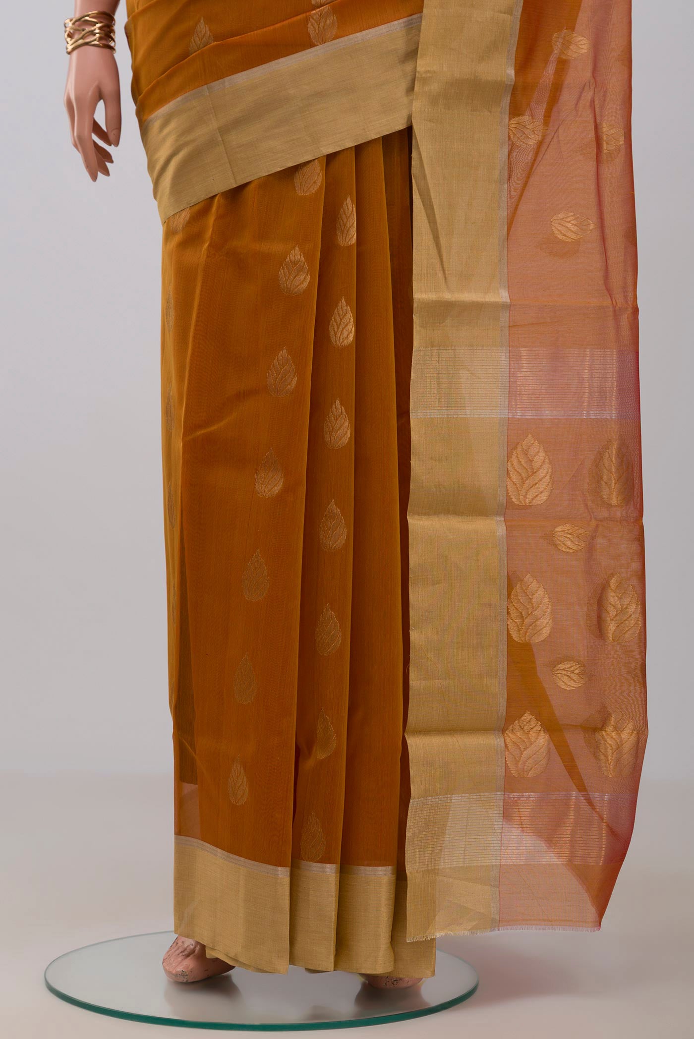 Pleats and pallu of Mustard Chanderi Silk Cotton Saree with Zari Butta on the body and Zari Border. 