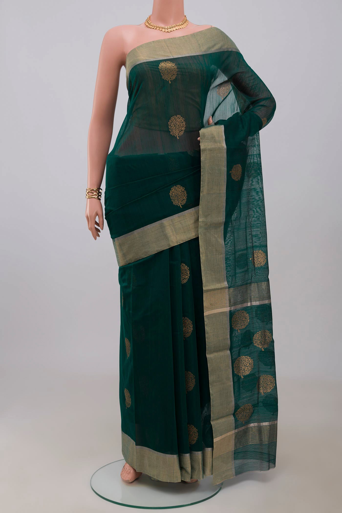 Green Chanderi Silk Cotton Saree with Zari Butta on the body and Zari Border.  displayed on a mannequin