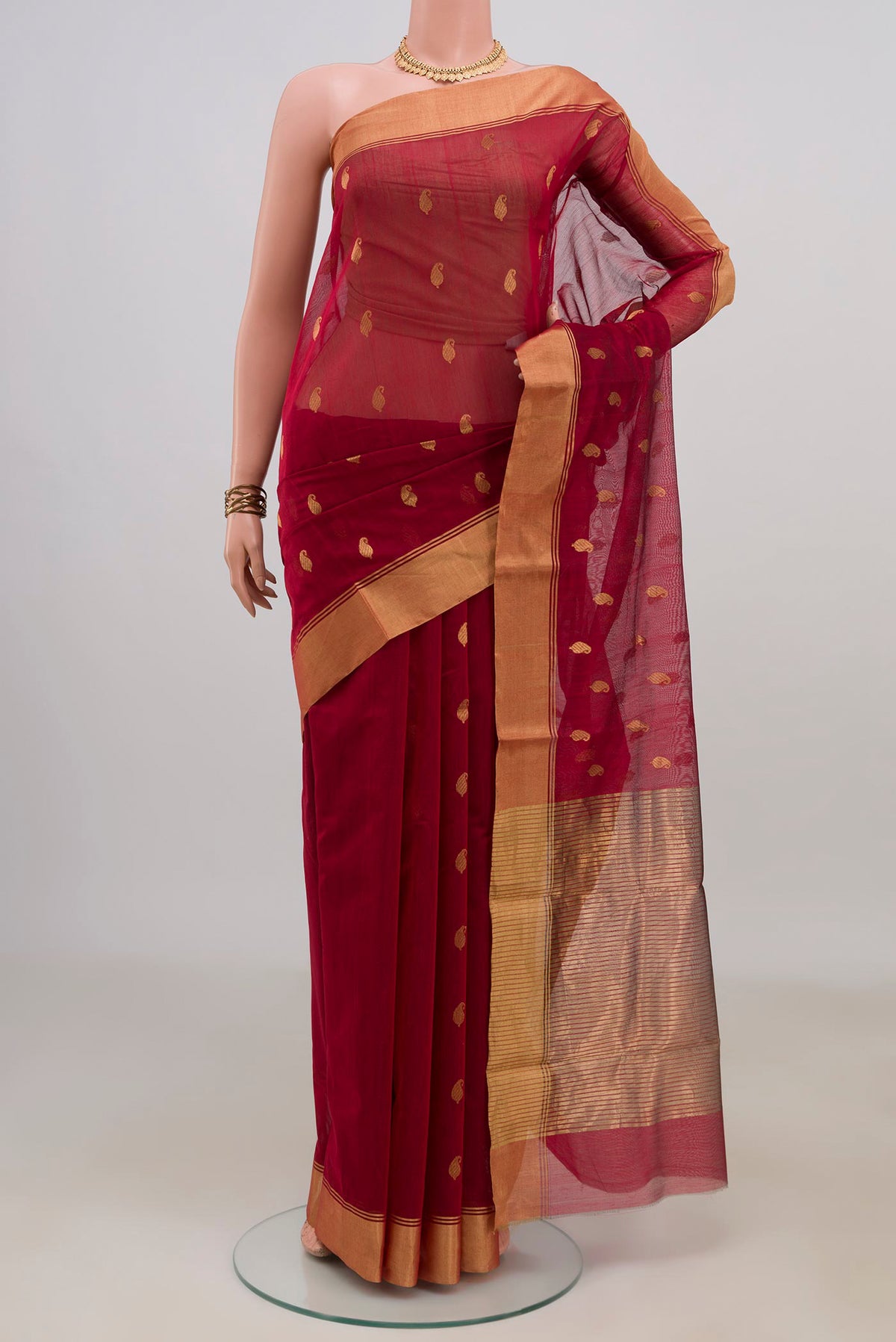 Maroon Chanderi Cotton Saree with Zari Butta on the body and Zari Border.  displayed on a mannequin