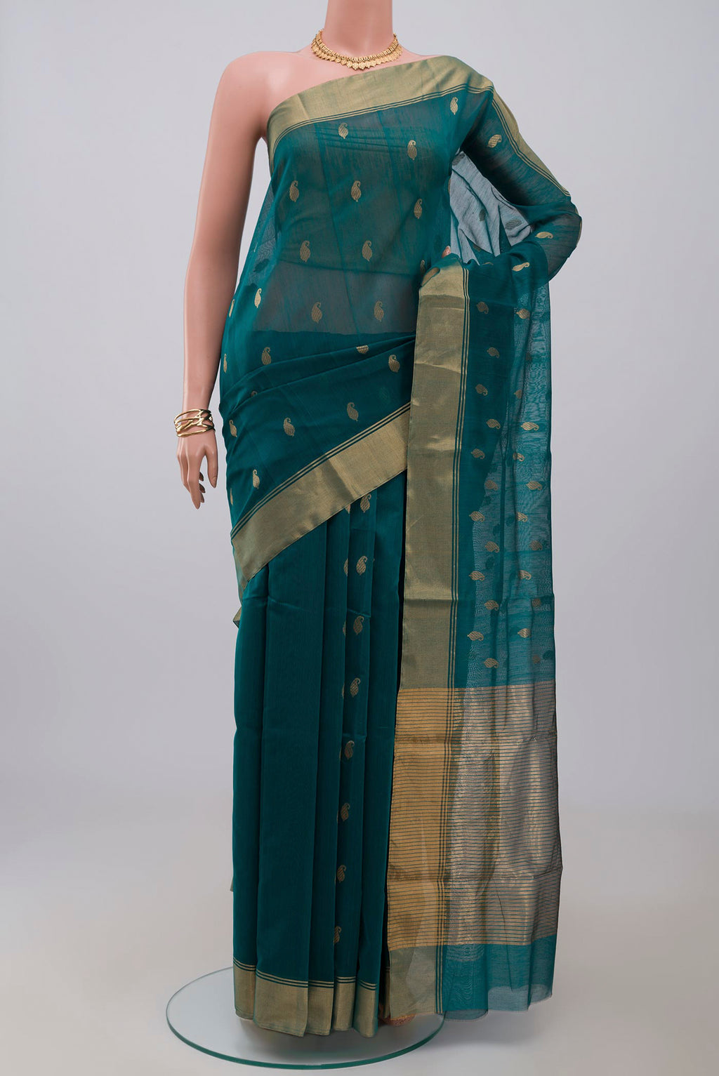 Green Chanderi Silk Cotton Saree with Zari Butta on the body and Zari Border.  displayed on a mannequin