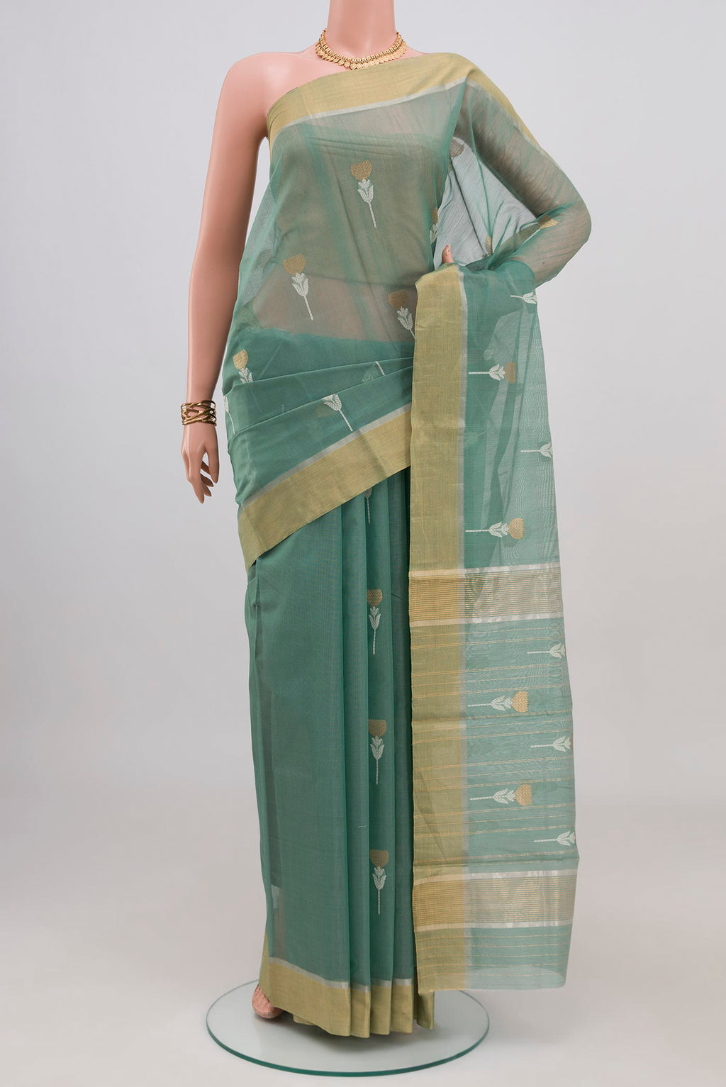 Sage Green Chanderi Silk Cotton Saree with Zari Butta on the body and Zari Border.  displayed on a mannequin