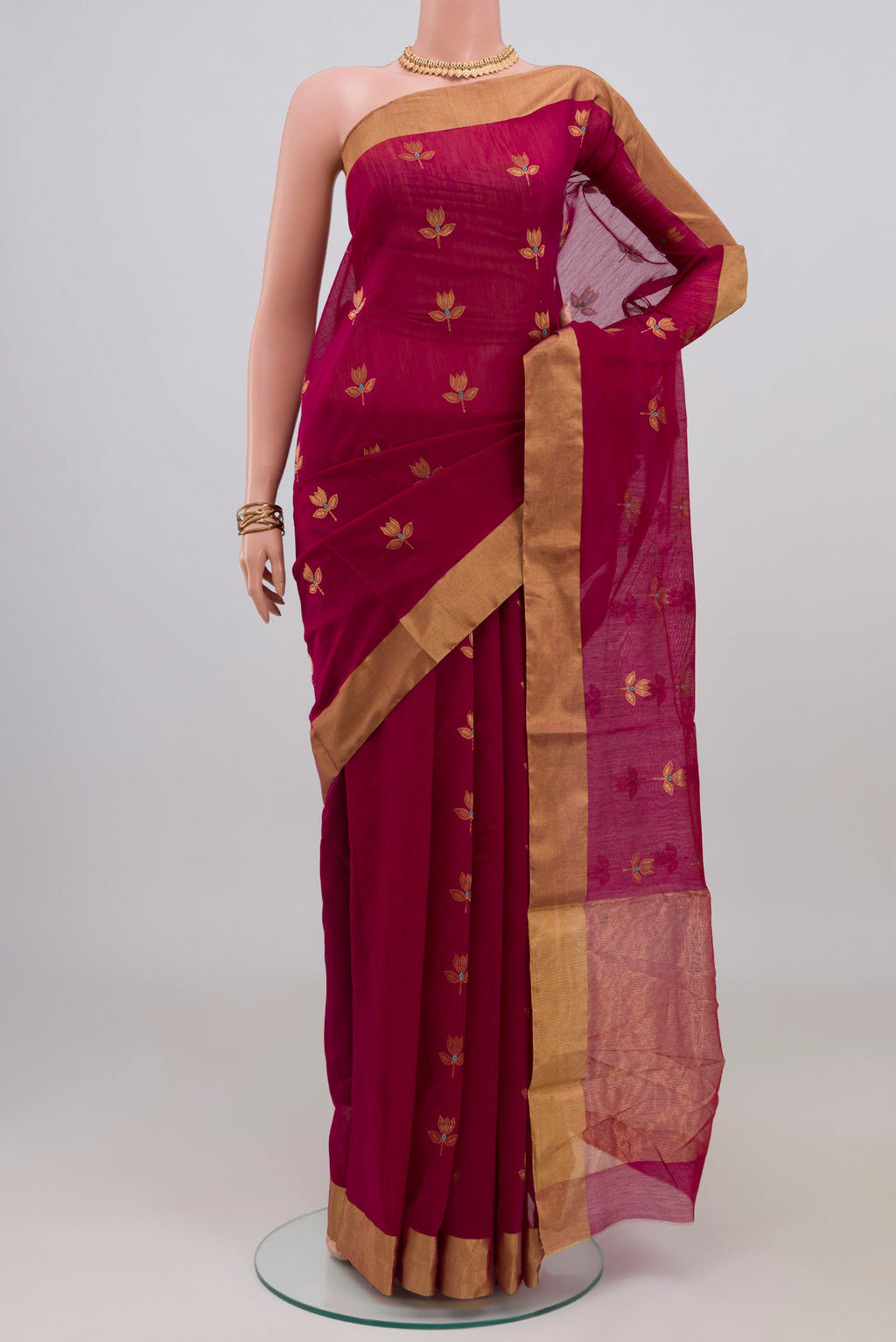 Maroon Chanderi Silk Cotton Saree with Zari Butta on the body and Zari Border.  displayed on a mannequin