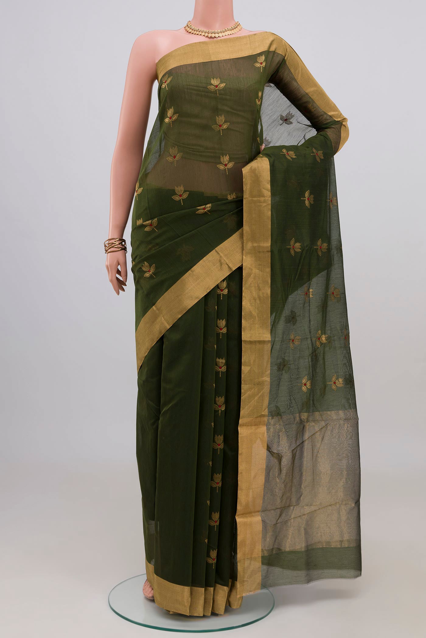 Mehandi Green Chanderi Silk Cotton Saree with Zari Butta on the body and Zari Border.  displayed on a mannequin