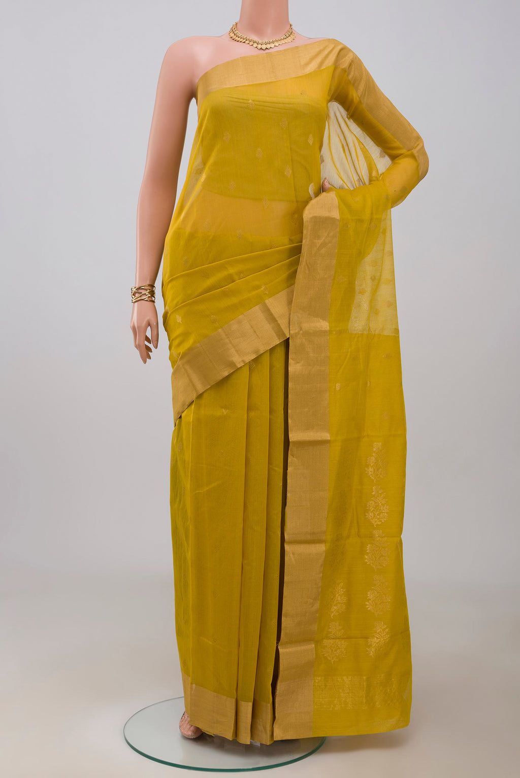 Mustard Chanderi Silk Cotton Saree with Zari Butta on the body and Zari Border.  displayed on a mannequin