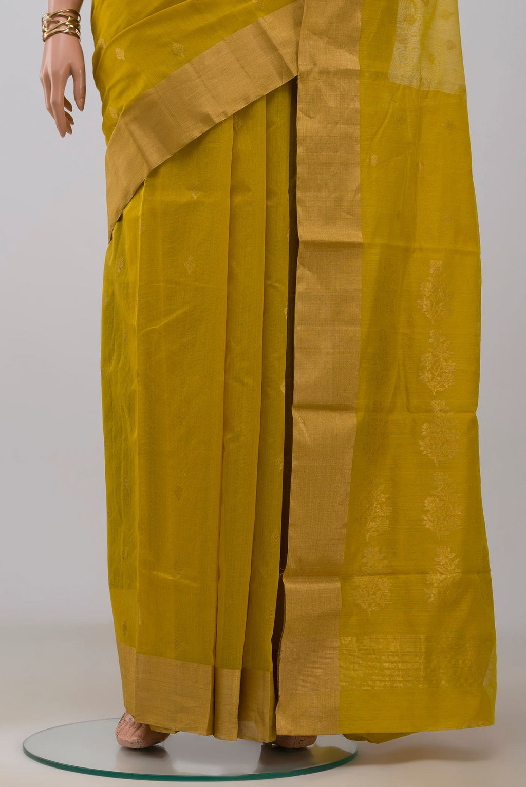 Pleats and pallu of Mustard Chanderi Silk Cotton Saree with Zari Butta on the body and Zari Border. 