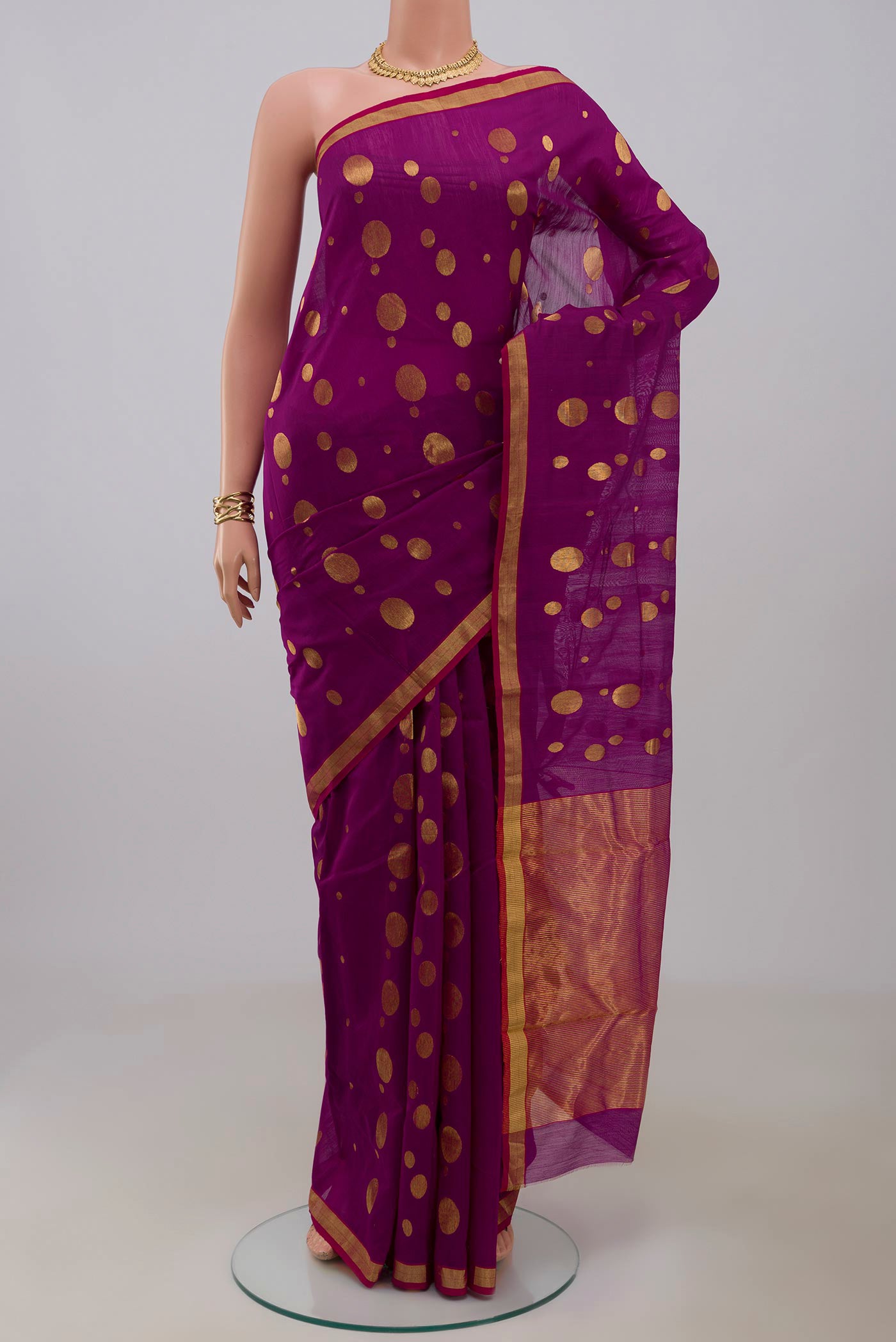 Magenta Chanderi Silk Cotton Saree with Zari Butta on the body and Zari Border.  displayed on a mannequin