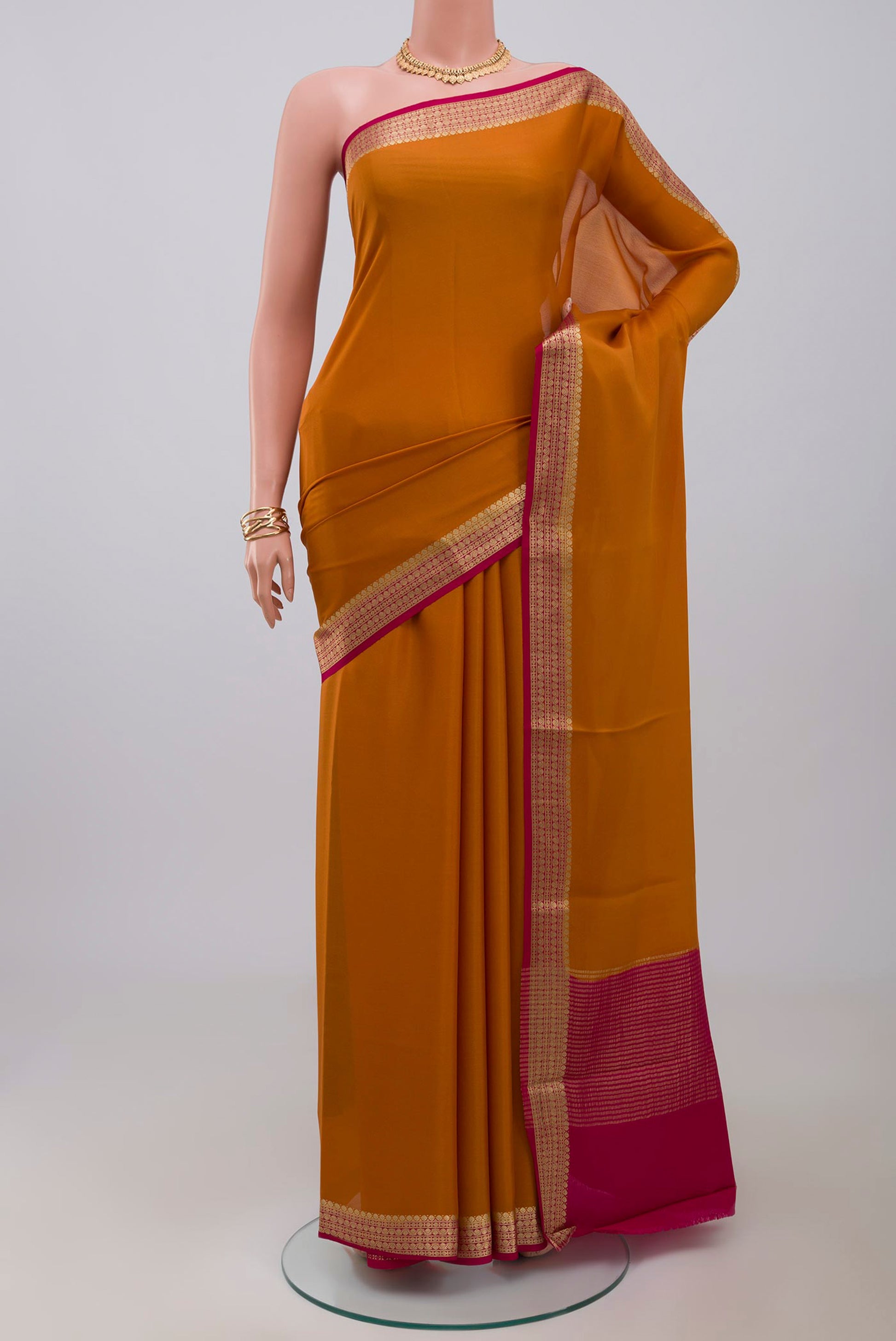 Yellow Mysore Crepe Saree with Plain Body and Zari Border.  displayed on a mannequin