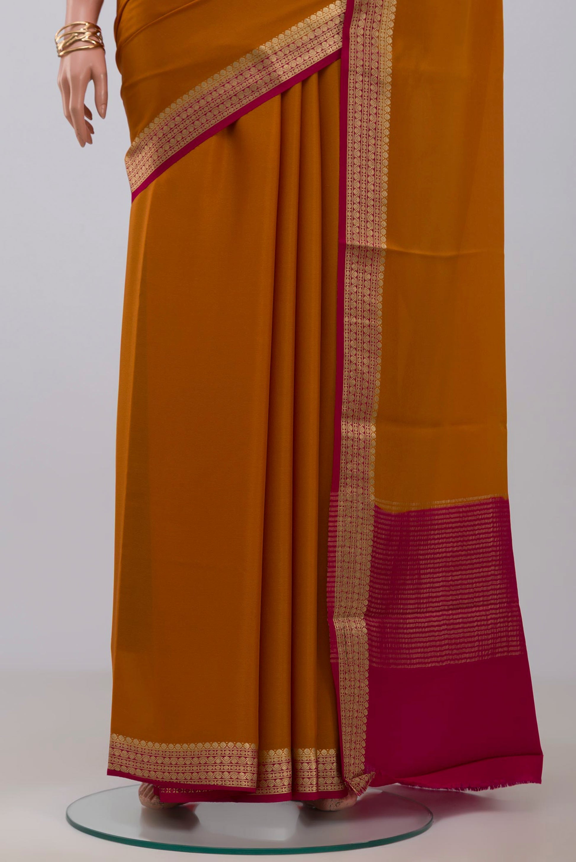 Pleats and pallu of Yellow Mysore Crepe Saree with Plain Body and Zari Border. 