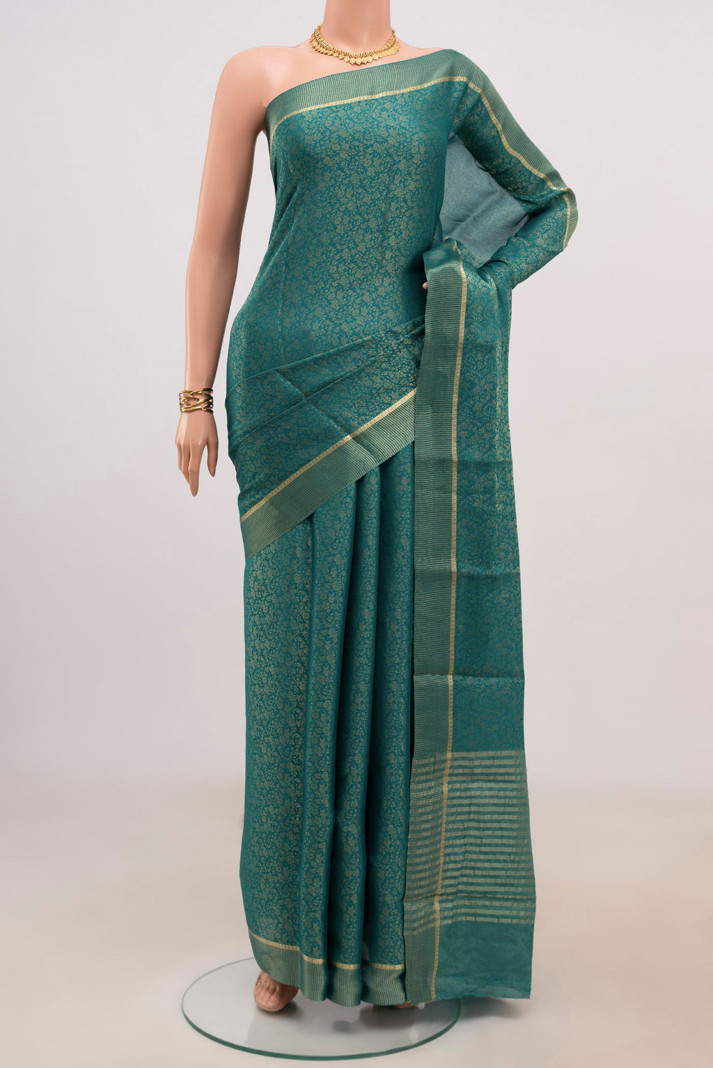 Peacock Blue Mysore Georgette Saree with Fancy on the body and Zari Border.  displayed on a mannequin