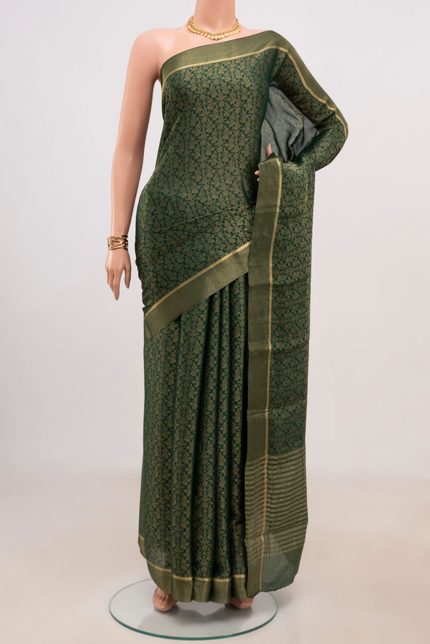 Green Mysore Georgette Saree with Fancy on the body and Zari Border.  displayed on a mannequin