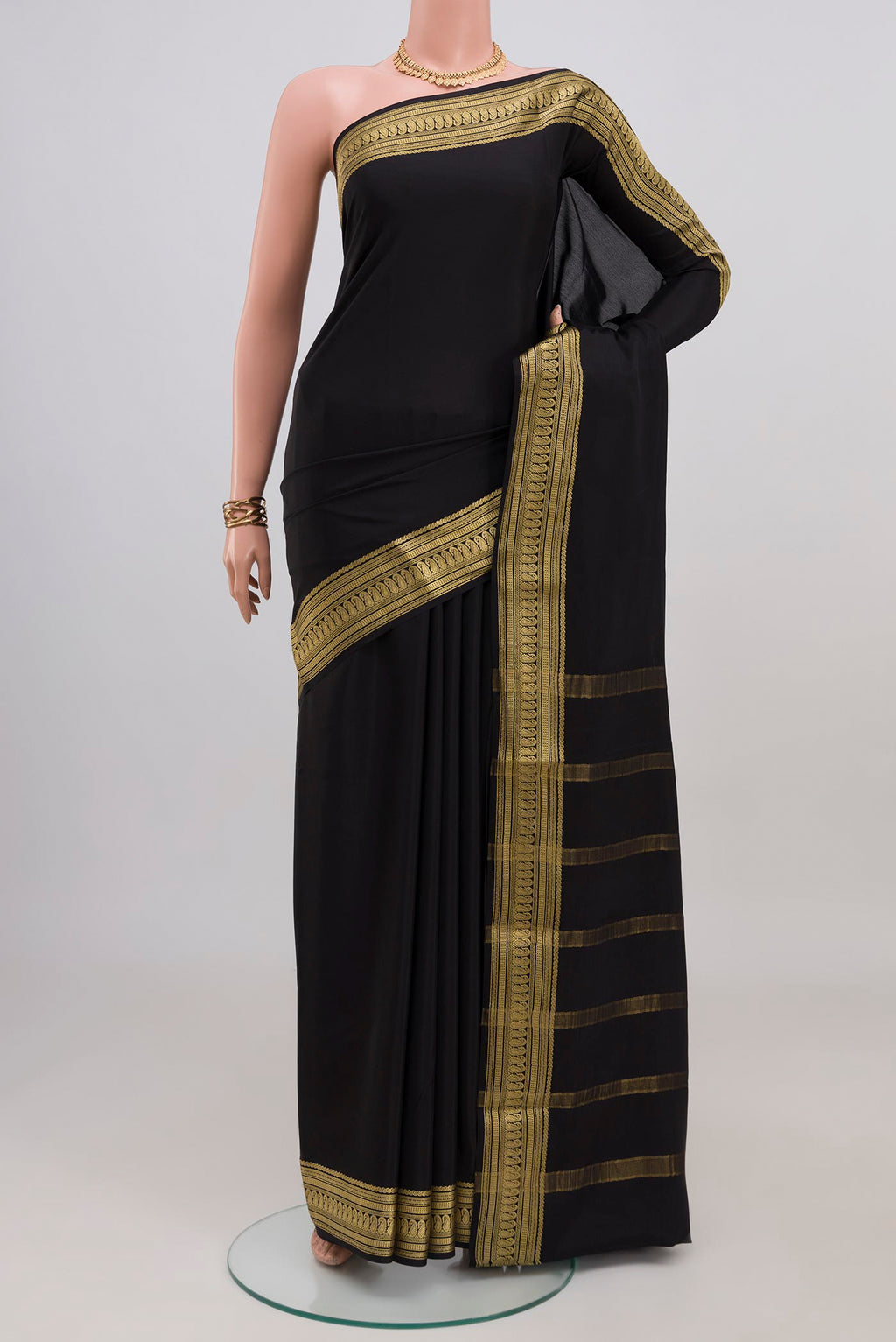 Black Mysore Crepe Saree with Plain Body and Zari Border.  displayed on a mannequin