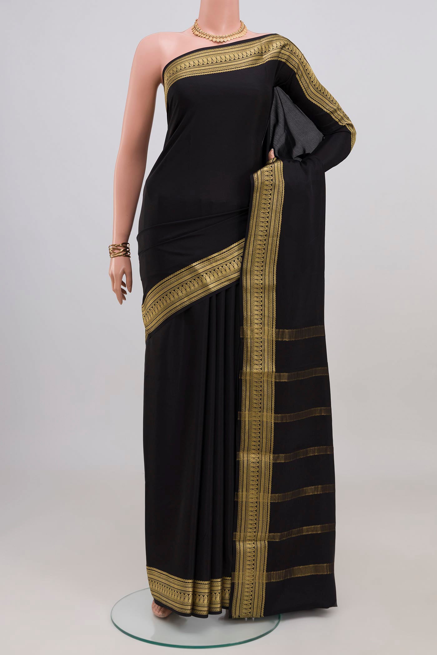 Black Mysore Crepe Saree with Plain Body and Zari Border.  displayed on a mannequin