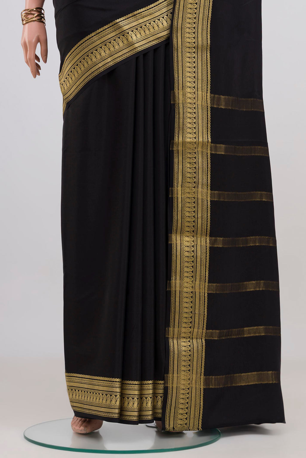 Pleats and pallu of Black Mysore Crepe Saree with Plain Body and Zari Border. 