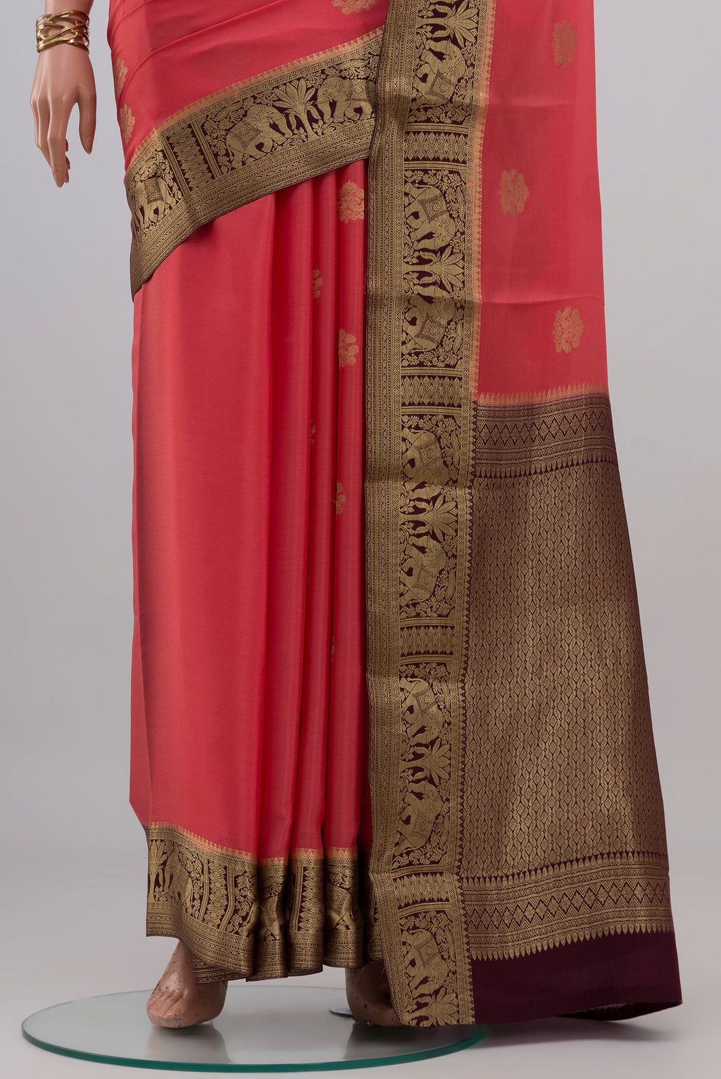 Pleats and pallu of Coral Mysore Crepe Saree with Zari Butta on the body and Zari Border. 