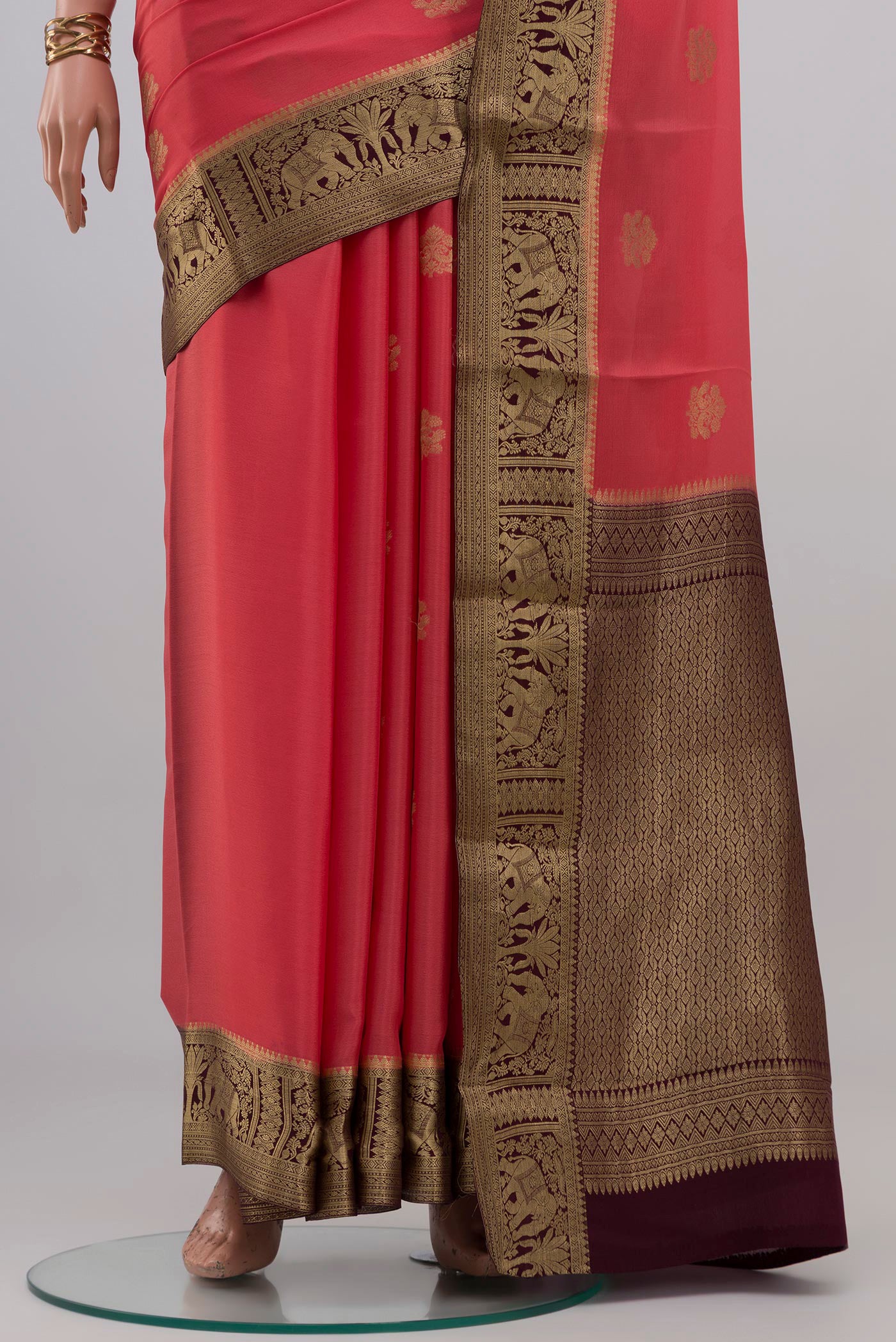Pleats and pallu of Coral Mysore Crepe Saree with Zari Butta on the body and Zari Border. 