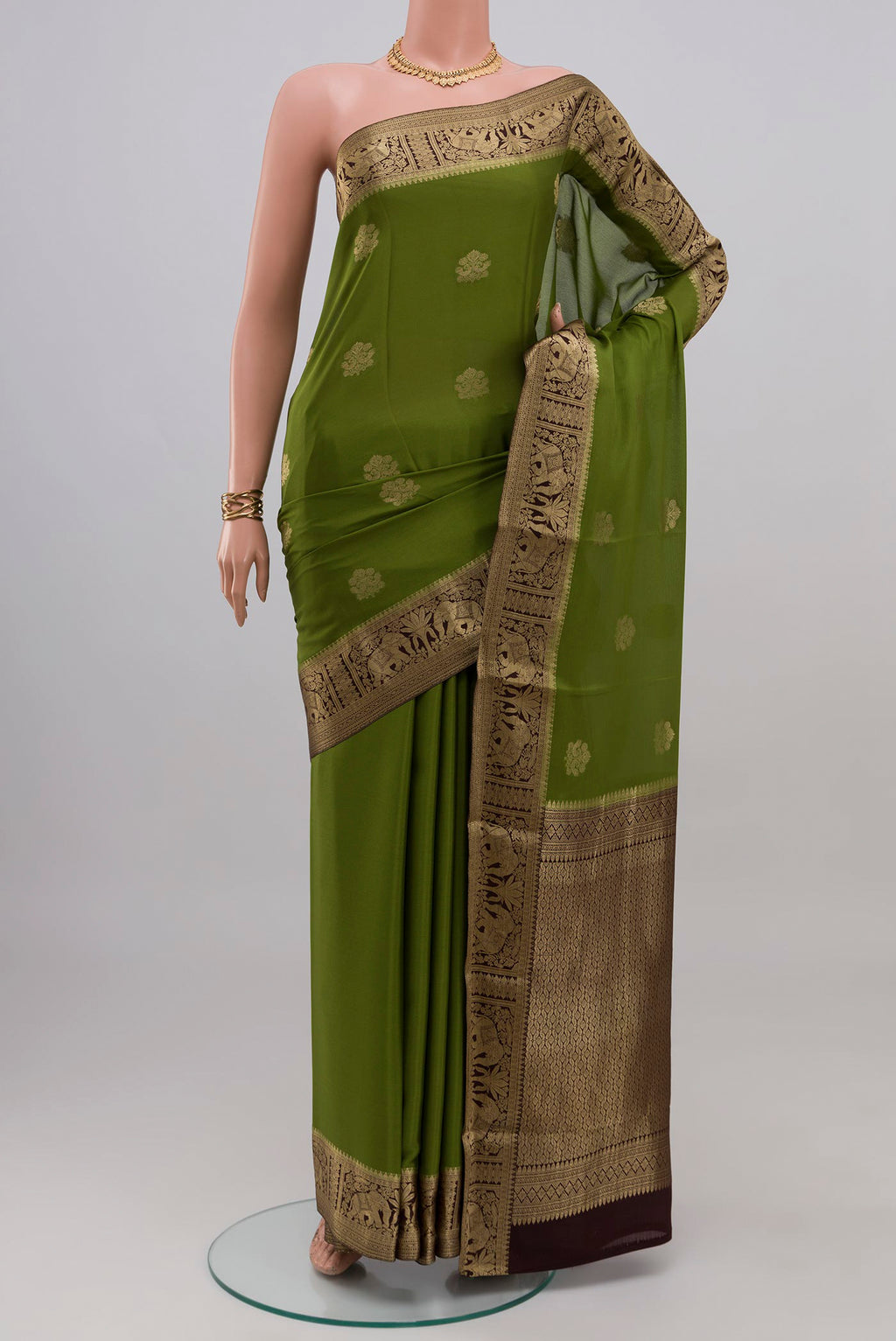 Mehandi Green Mysore Crepe Saree with Zari Butta on the body and Zari Border.  displayed on a mannequin