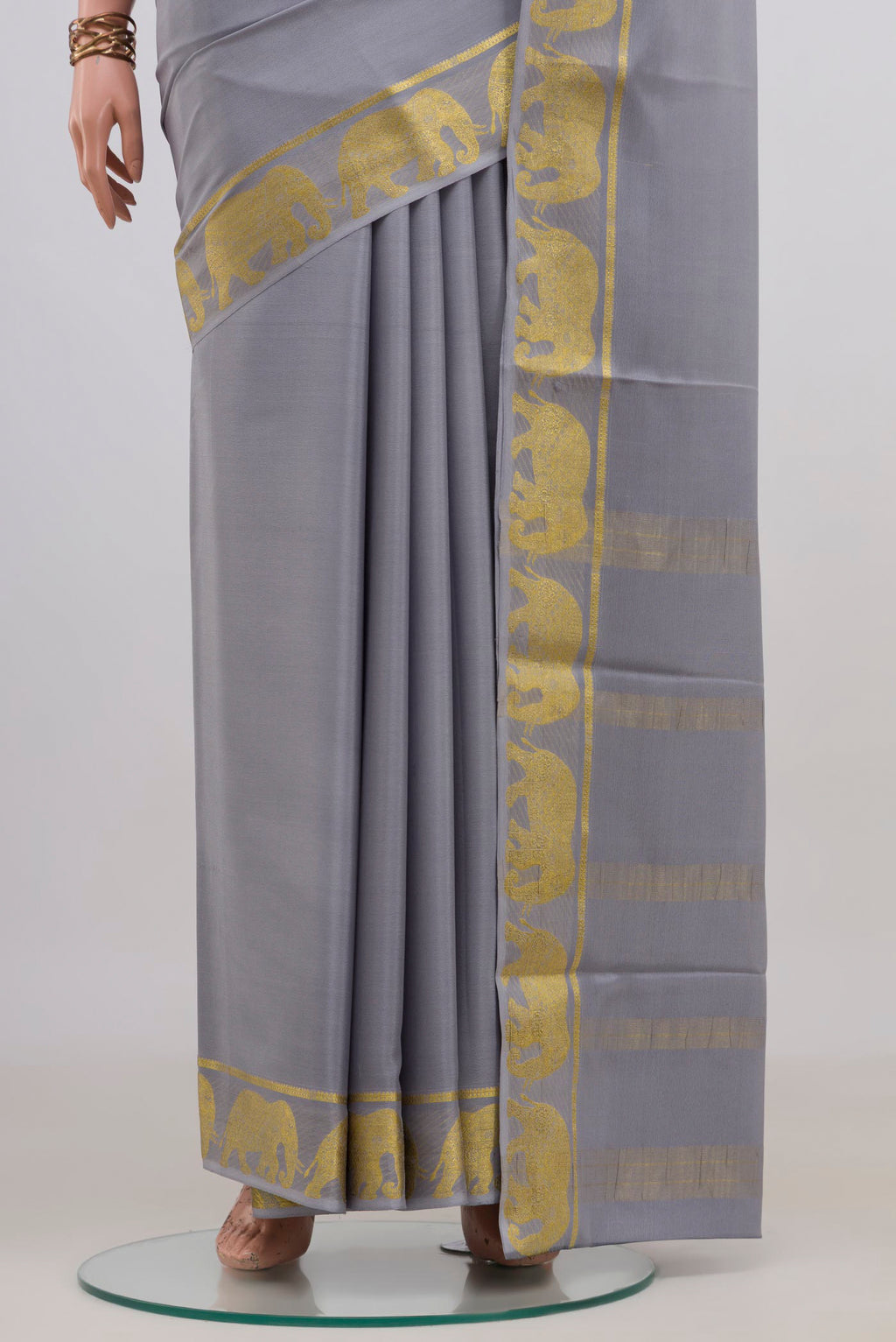 Pleats and pallu of Grey Mysore Crepe Saree with Plain Body and Fancy Border. 