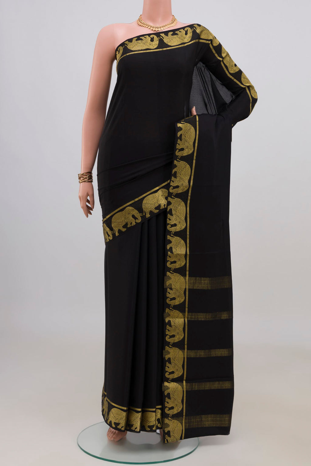 Black Mysore Crepe Saree with Plain Body and Fancy Border.  displayed on a mannequin
