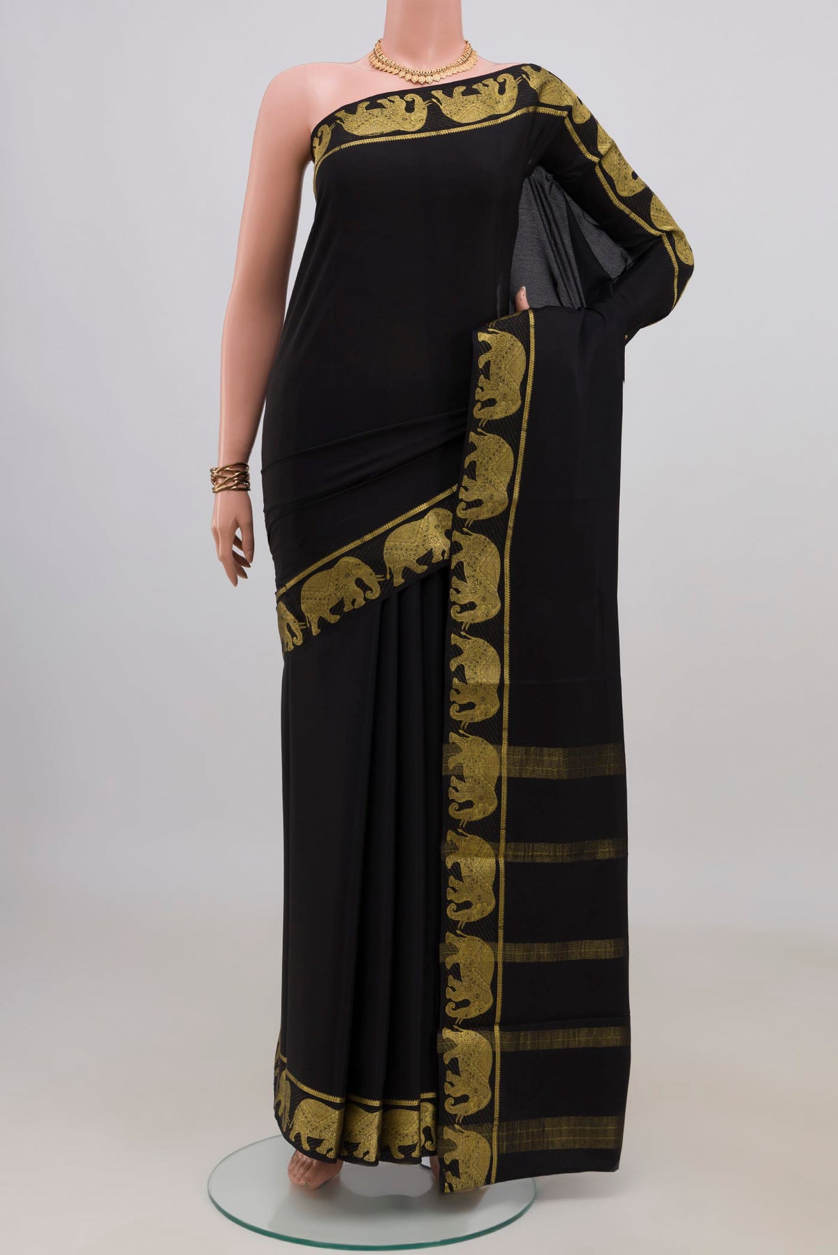 Black Mysore Crepe Saree with Plain Body and Fancy Border.  displayed on a mannequin
