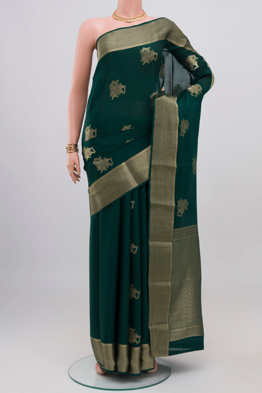Bottle Green Mysore Crepe Saree with Zari Butta on the body and Zari Border.  displayed on a mannequin