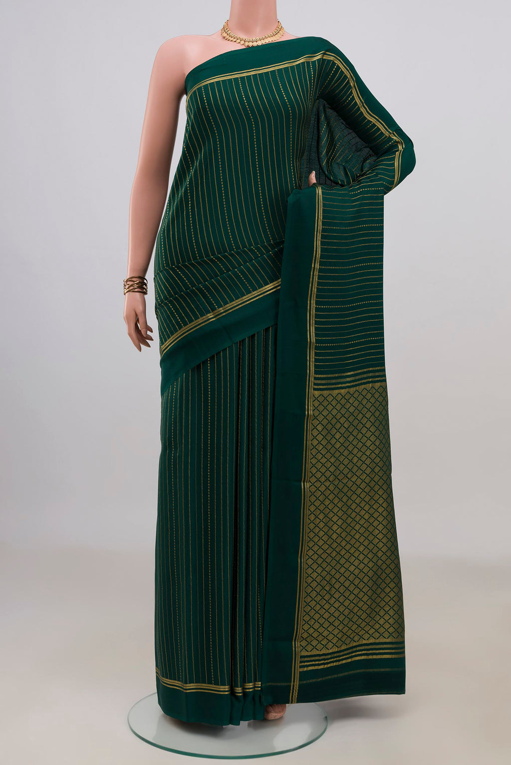 Bottle Green Mysore Crepe Saree with Stripes on the body and Thin Zari Line.  displayed on a mannequin