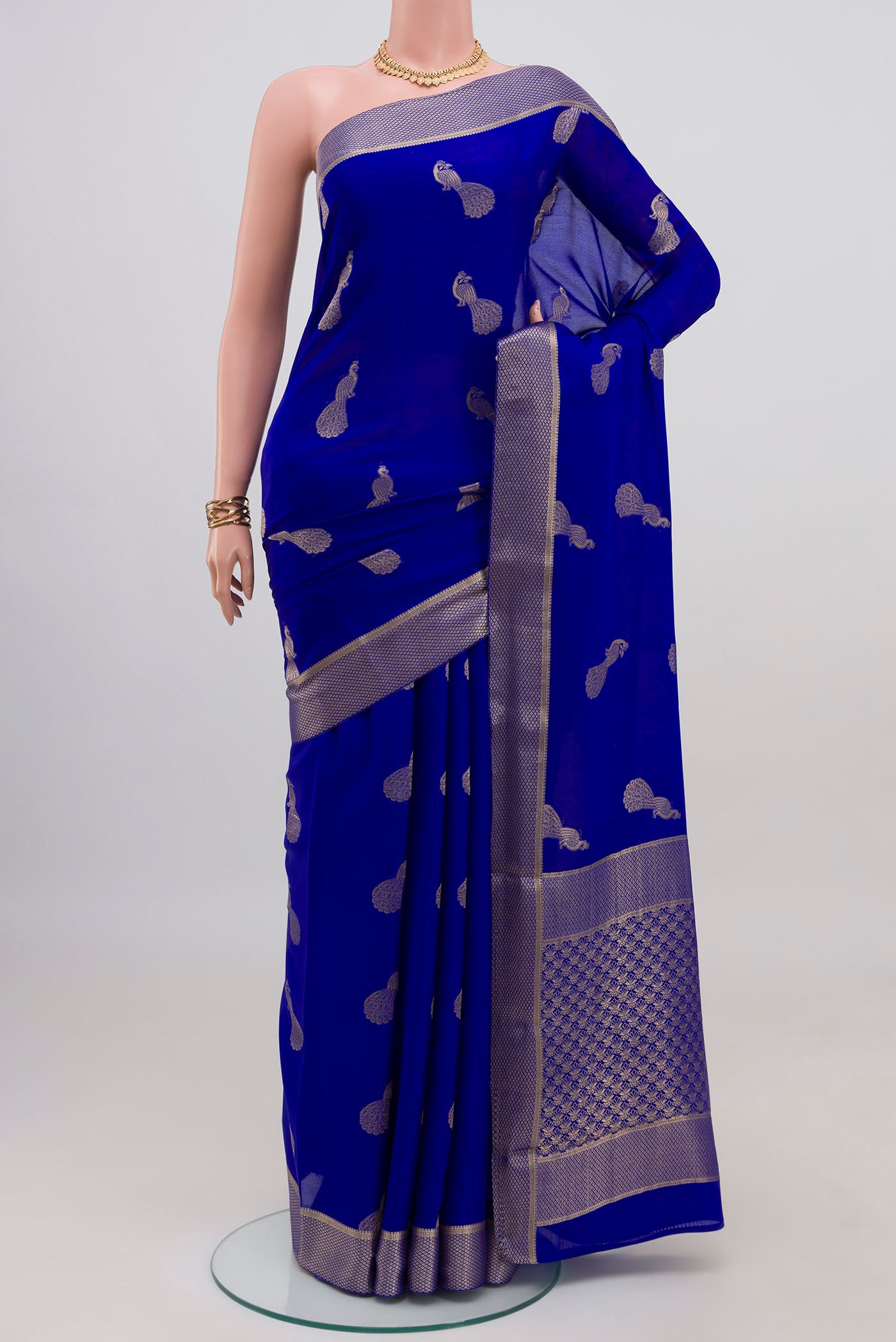 Royal Blue Mysore Crepe Saree with Zari Butta on the body and Zari Border.  displayed on a mannequin