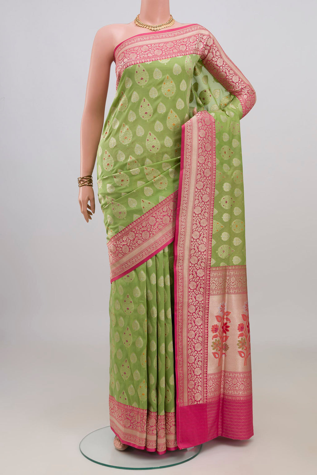 Pure Silk Green Banarasi Saree with Zari Butta on the body and Fancy Border.  displayed on a mannequin