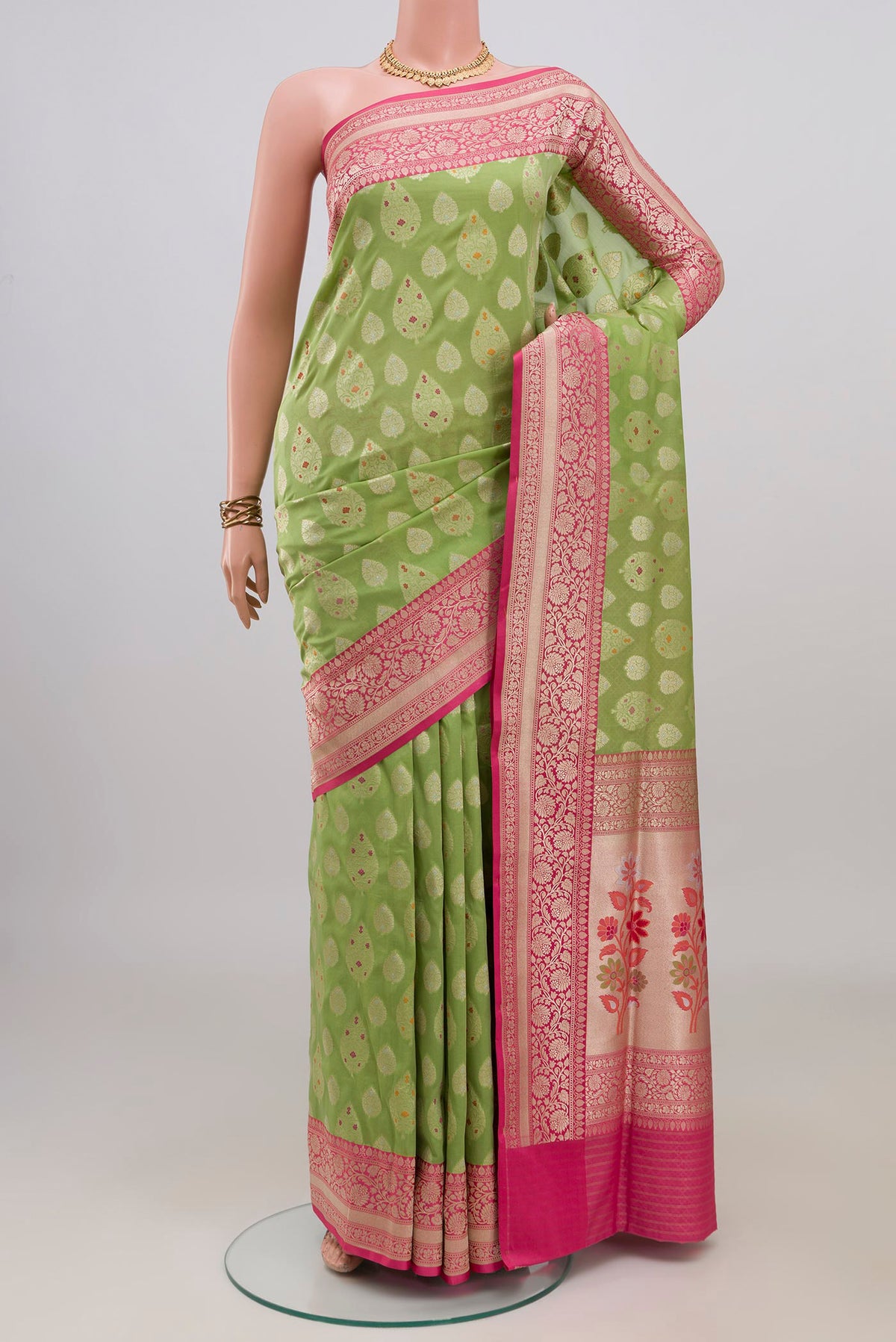 Pure Silk Green Banarasi Saree with Zari Butta on the body and Fancy Border.  displayed on a mannequin
