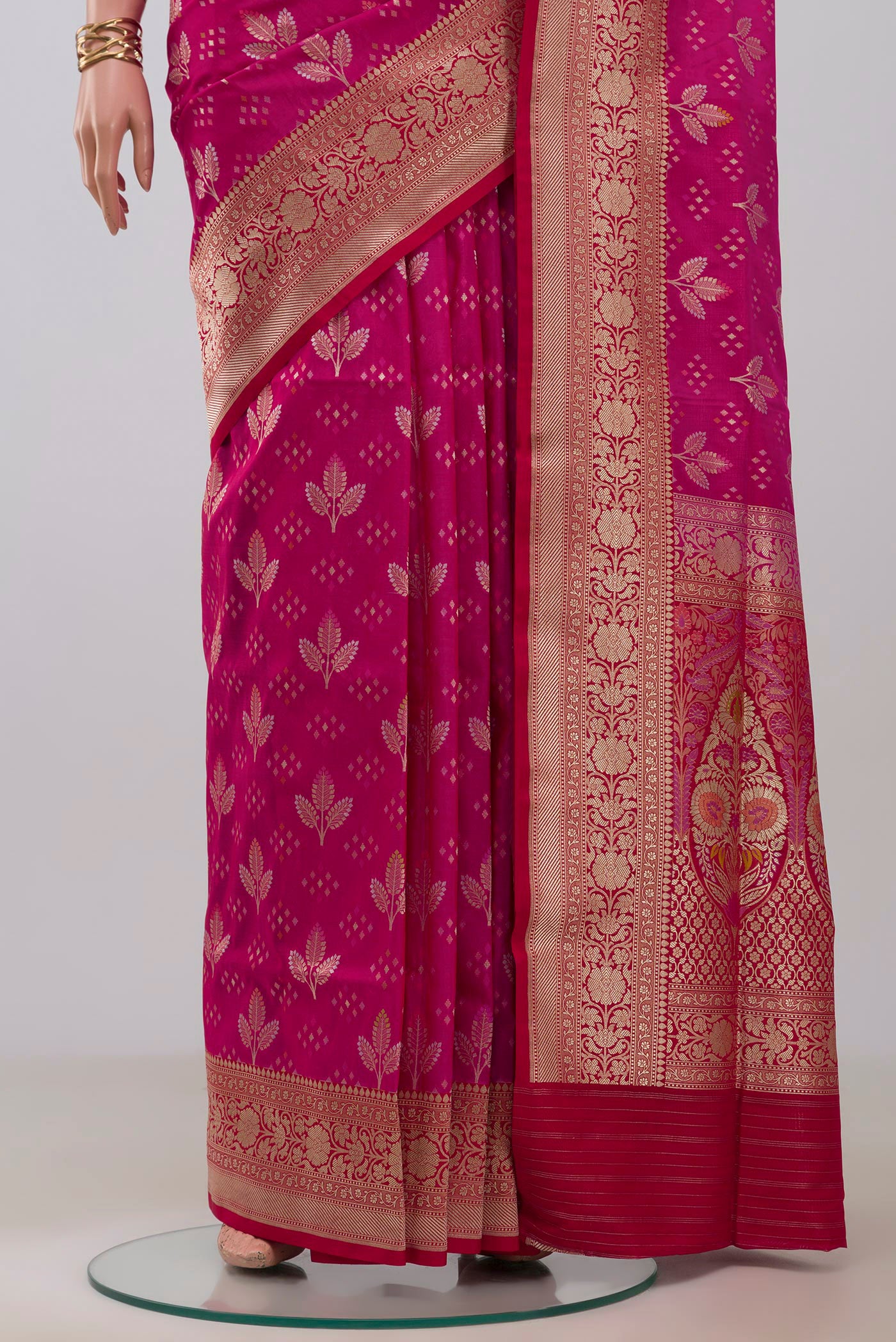 Pleats and pallu of Rani Pink Banarasi Silk Saree with Zari And Thread Butta on the body and Fancy Border. 