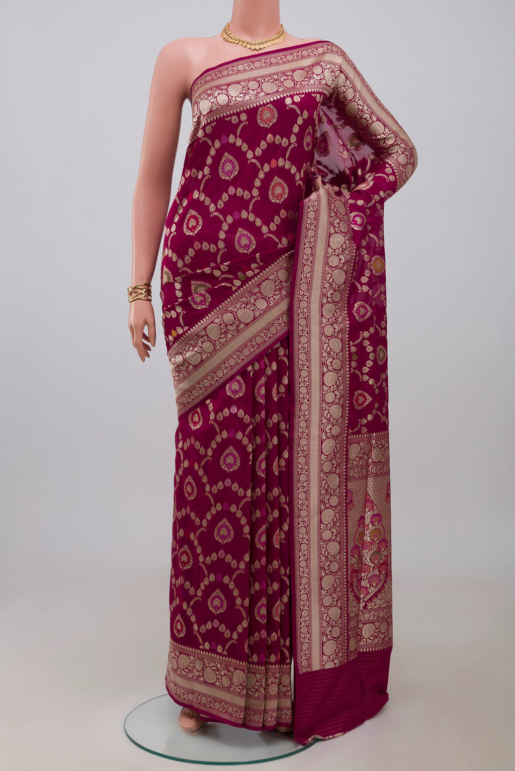 Burgundy Banarasi Silk Saree with Zari And Thread Butta on the body and Zari Border.  displayed on a mannequin