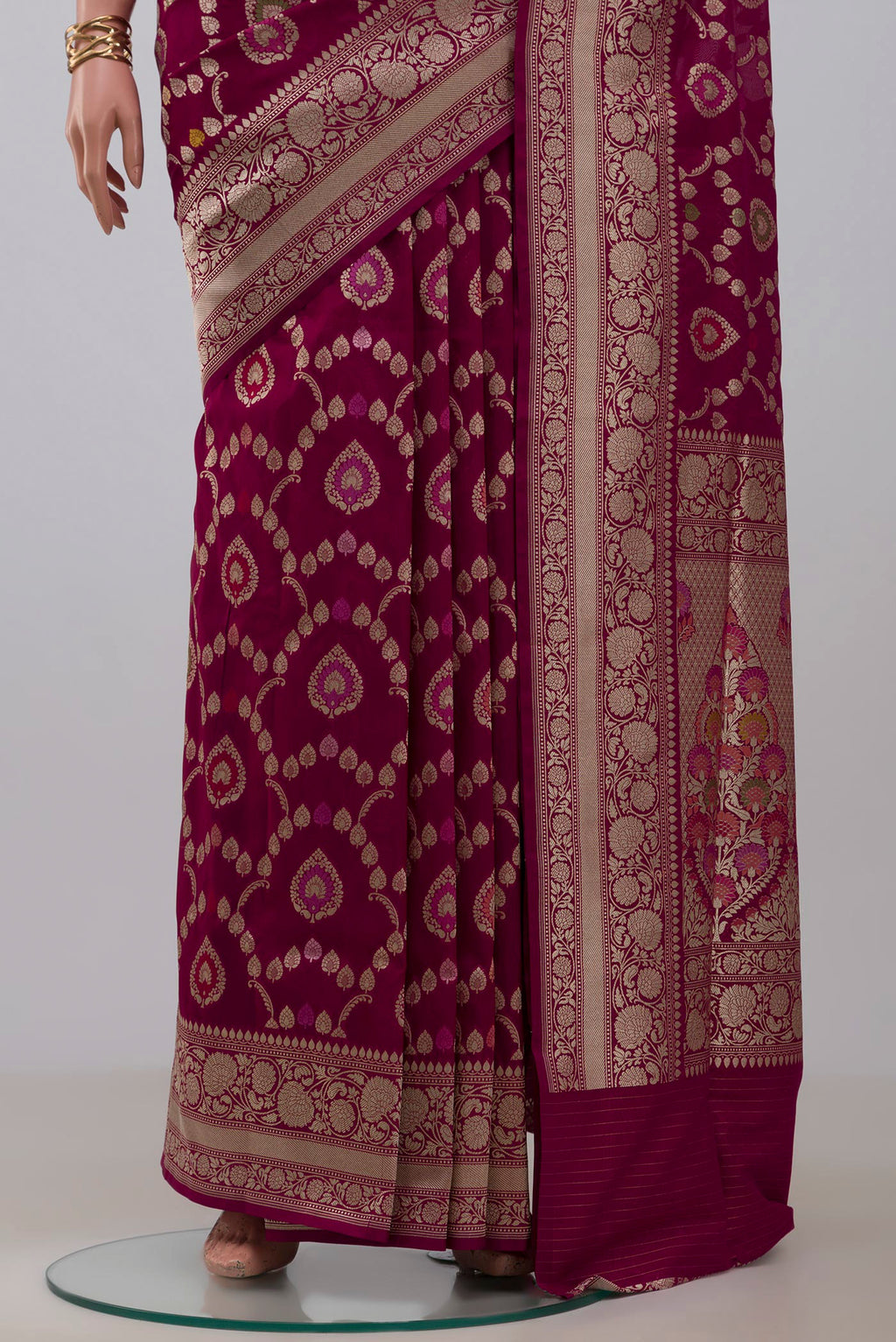 Pleats and pallu of Burgundy Banarasi Silk Saree with Zari And Thread Butta on the body and Zari Border. 