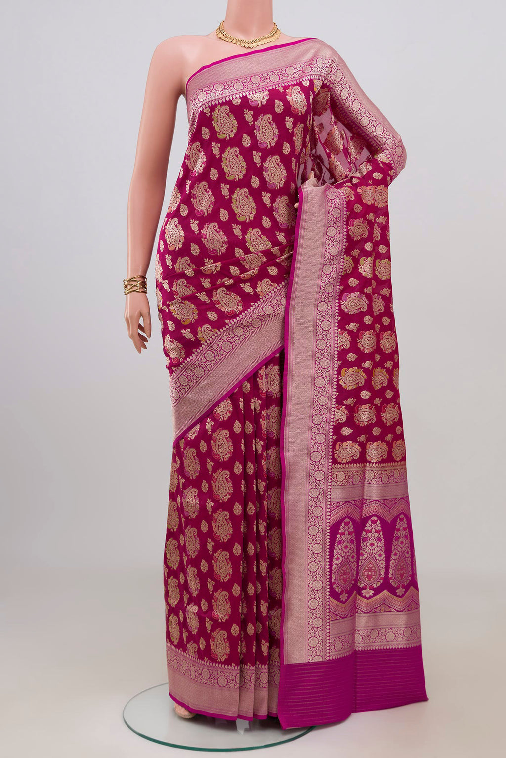 Magenta Banarasi Silk Saree with Zari Brocade on the body and Zari Border.  displayed on a mannequin