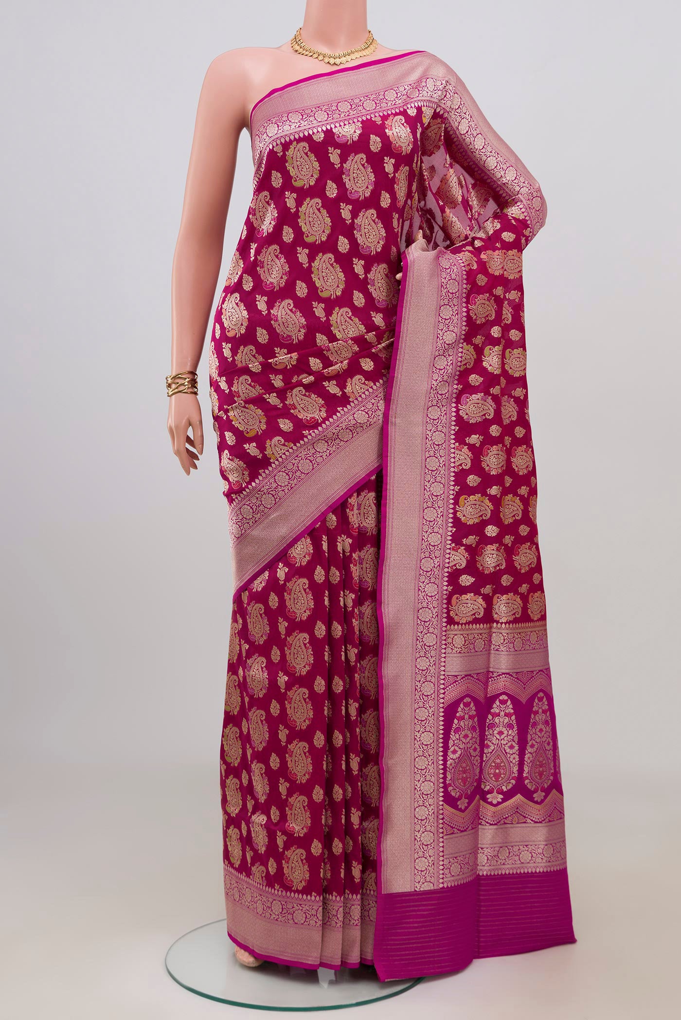 Magenta Banarasi Silk Saree with Zari Brocade on the body and Zari Border.  displayed on a mannequin