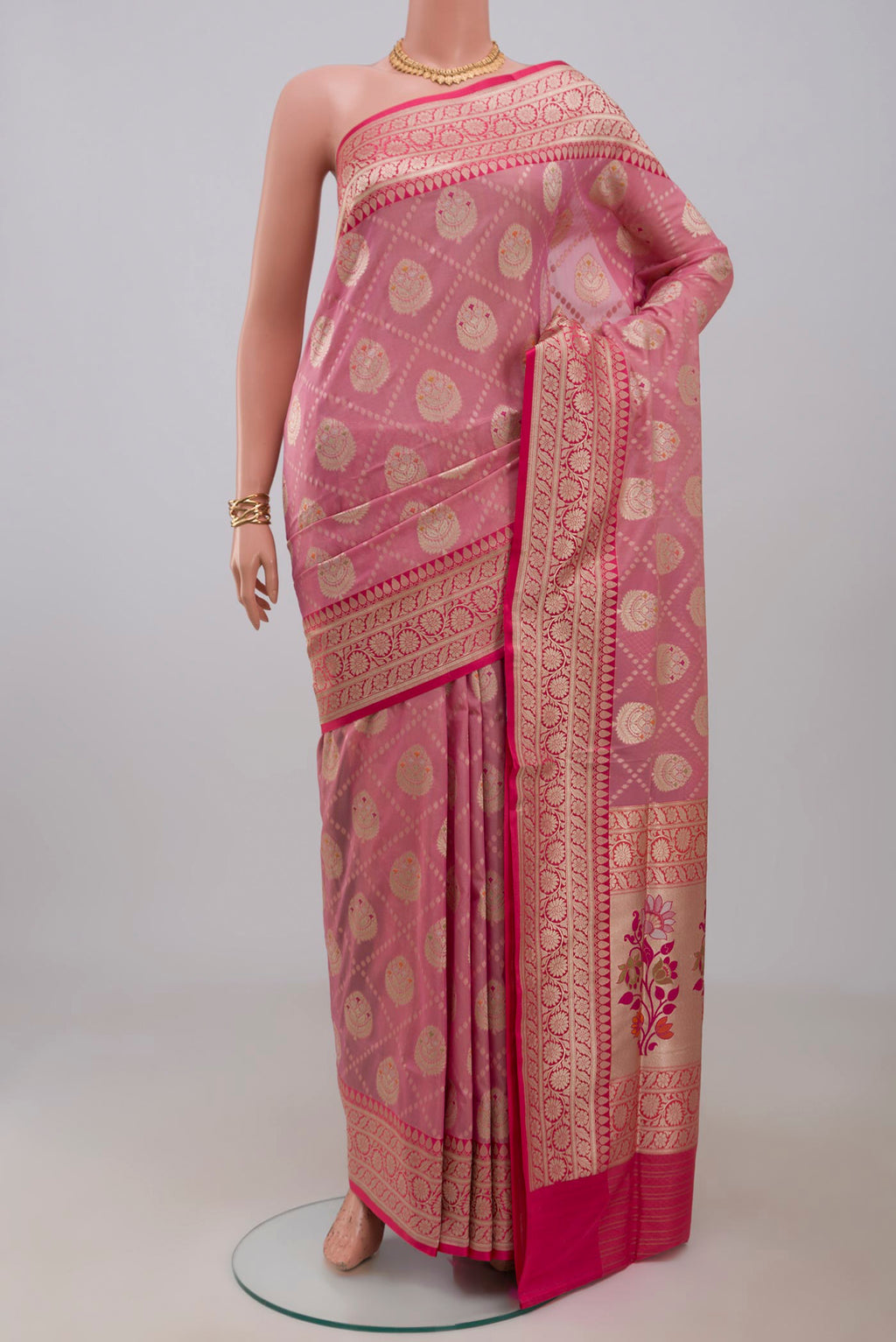 Peach Banarasi Saree with Fancy on the body and Fancy Border.  displayed on a mannequin