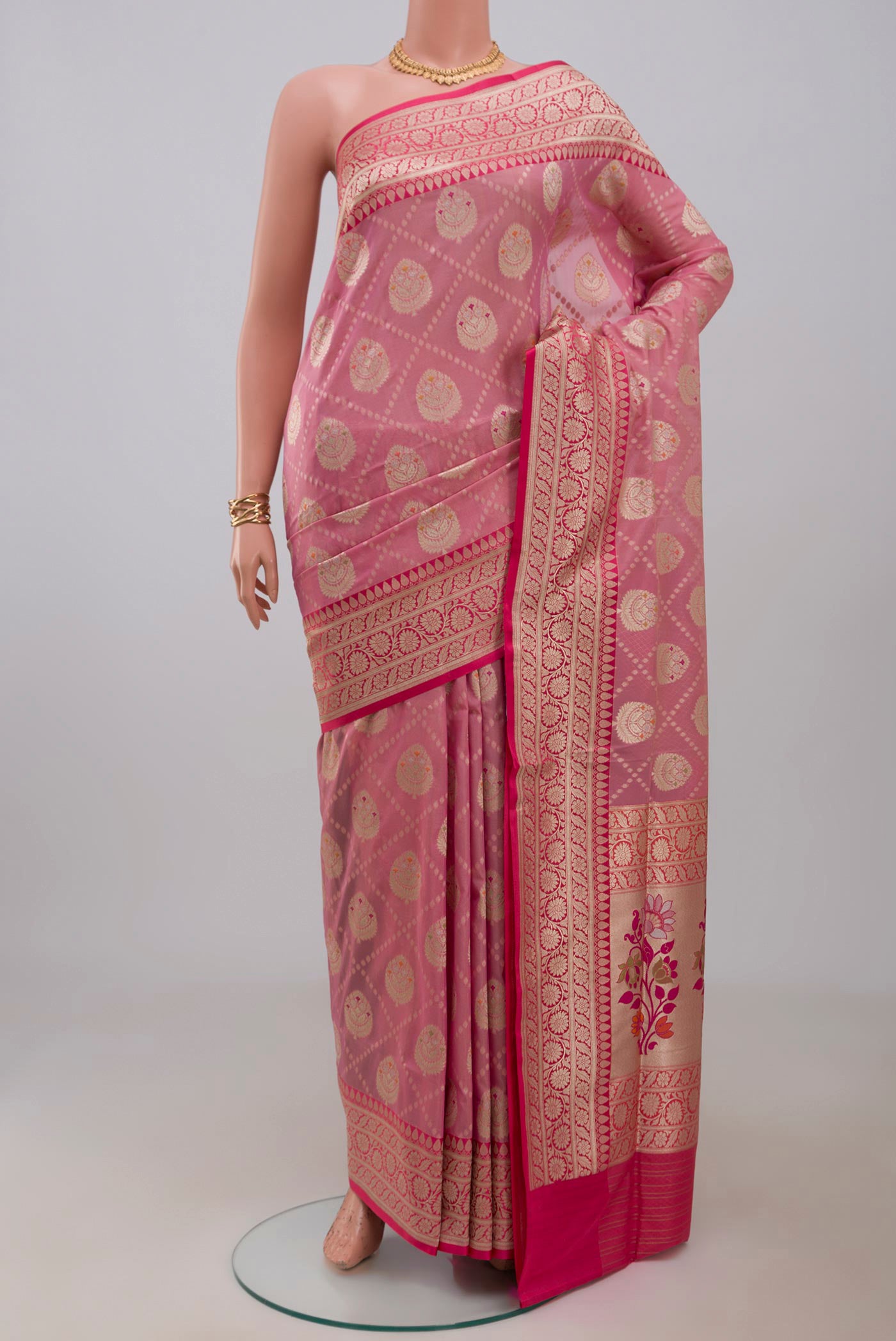 Peach Banarasi Saree with Fancy on the body and Fancy Border.  displayed on a mannequin
