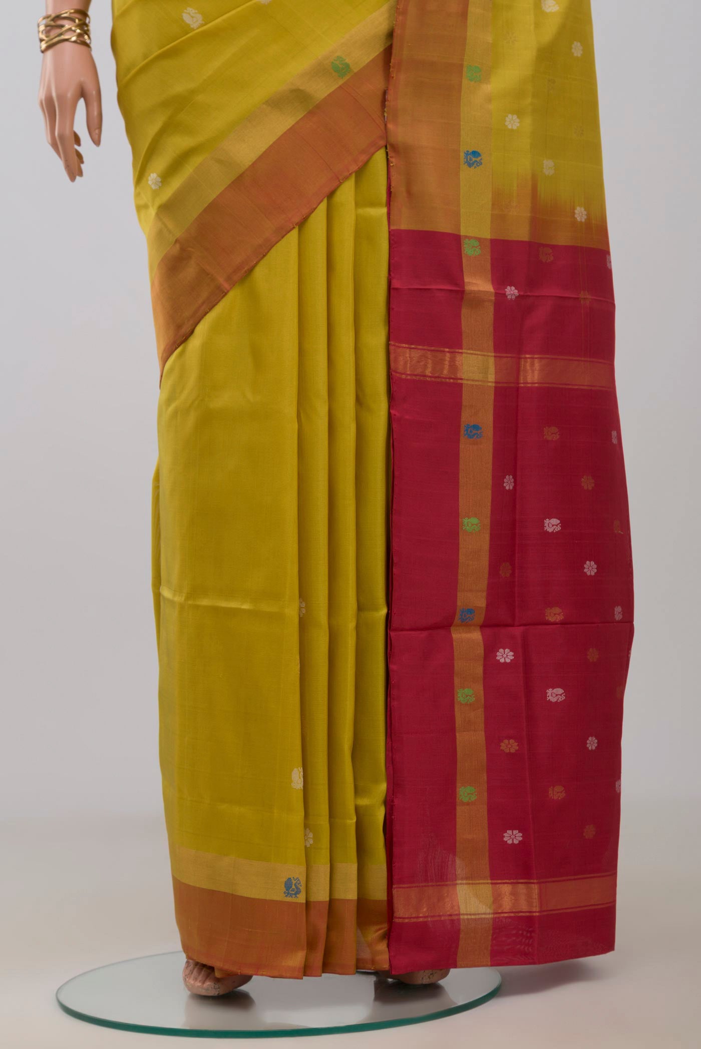 Pleats and pallu of Yellow Uppada Silk Saree with Zari And Thread Butta on the body and Fancy Border. 
