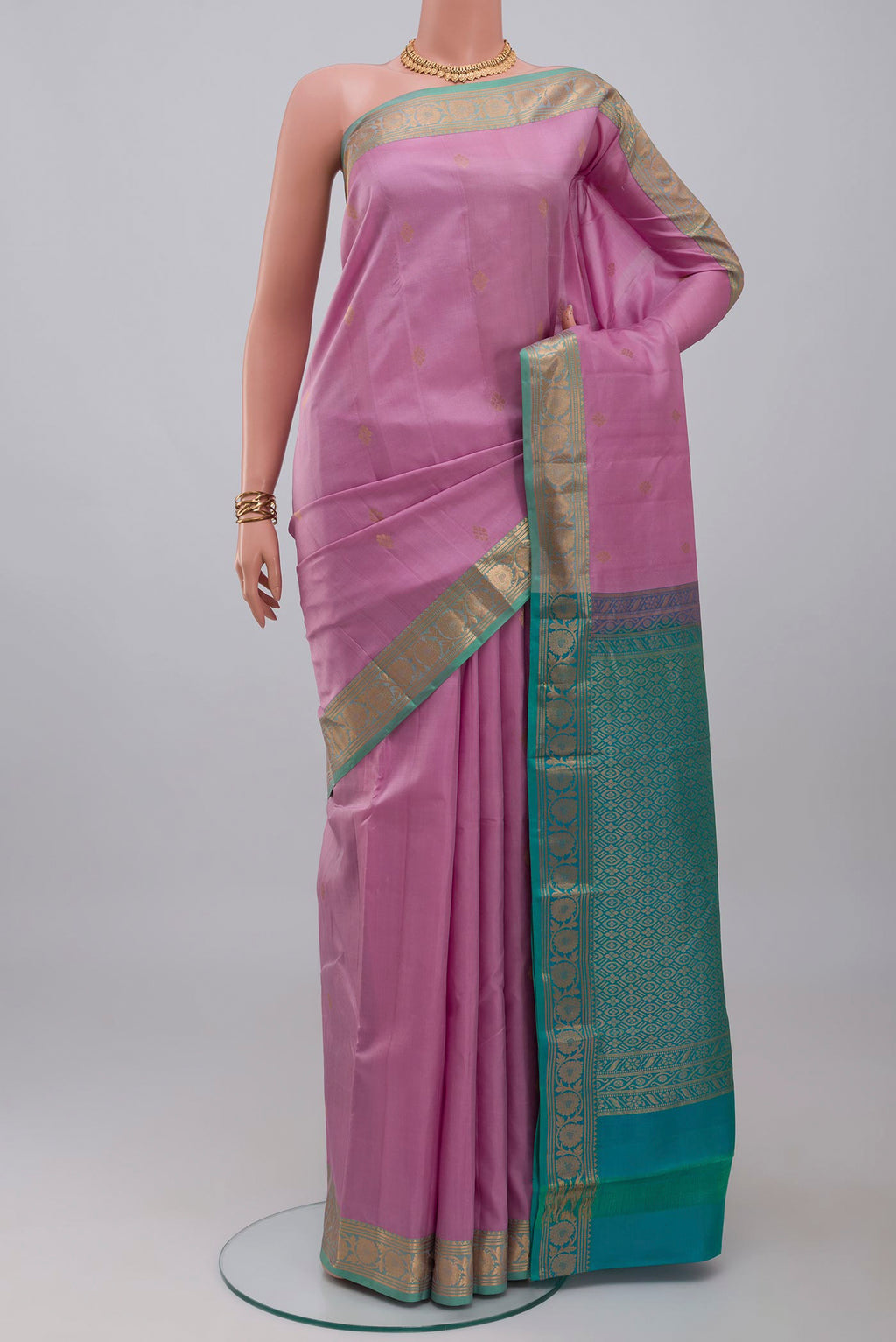 Lavender Kanchipuram Silk Saree with Zari Butta on the body and Zari Border.  displayed on a mannequin