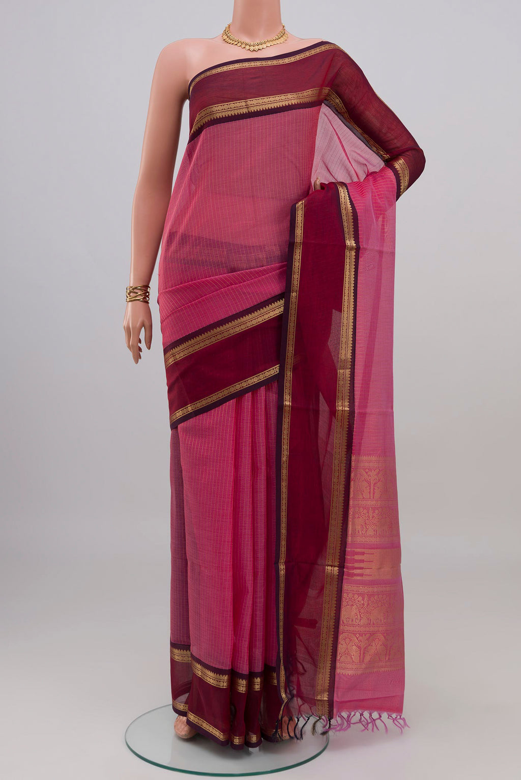 Pink Silk Cotton Saree with Checked design on the body and Zari Border.  displayed on a mannequin